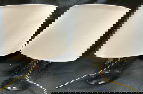 Pair Art glass Lamps W Harps & Shades: Lot includes 2 lamps. Each are glass. Lamps each include white toned shades & gilt metal harps. Each have twist switches to bulb sockets. Lamps each measure approximately 18 inches tall 7 inches wide