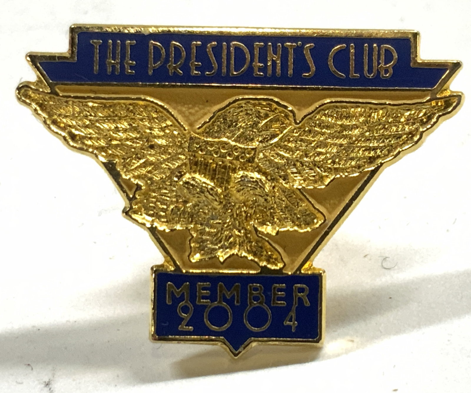 THE PRESIDENTS CLUB Vtg gilt & Enamel Pin: Pin reads THE PRESIDENTS CLUB MEMBER 2004. Pin is gilt and enamel. Piece has yellow and orange toned with gilt detail of eagle. Piece measures approximately 1 inch wide .75 inches tall. Pin, enamel an