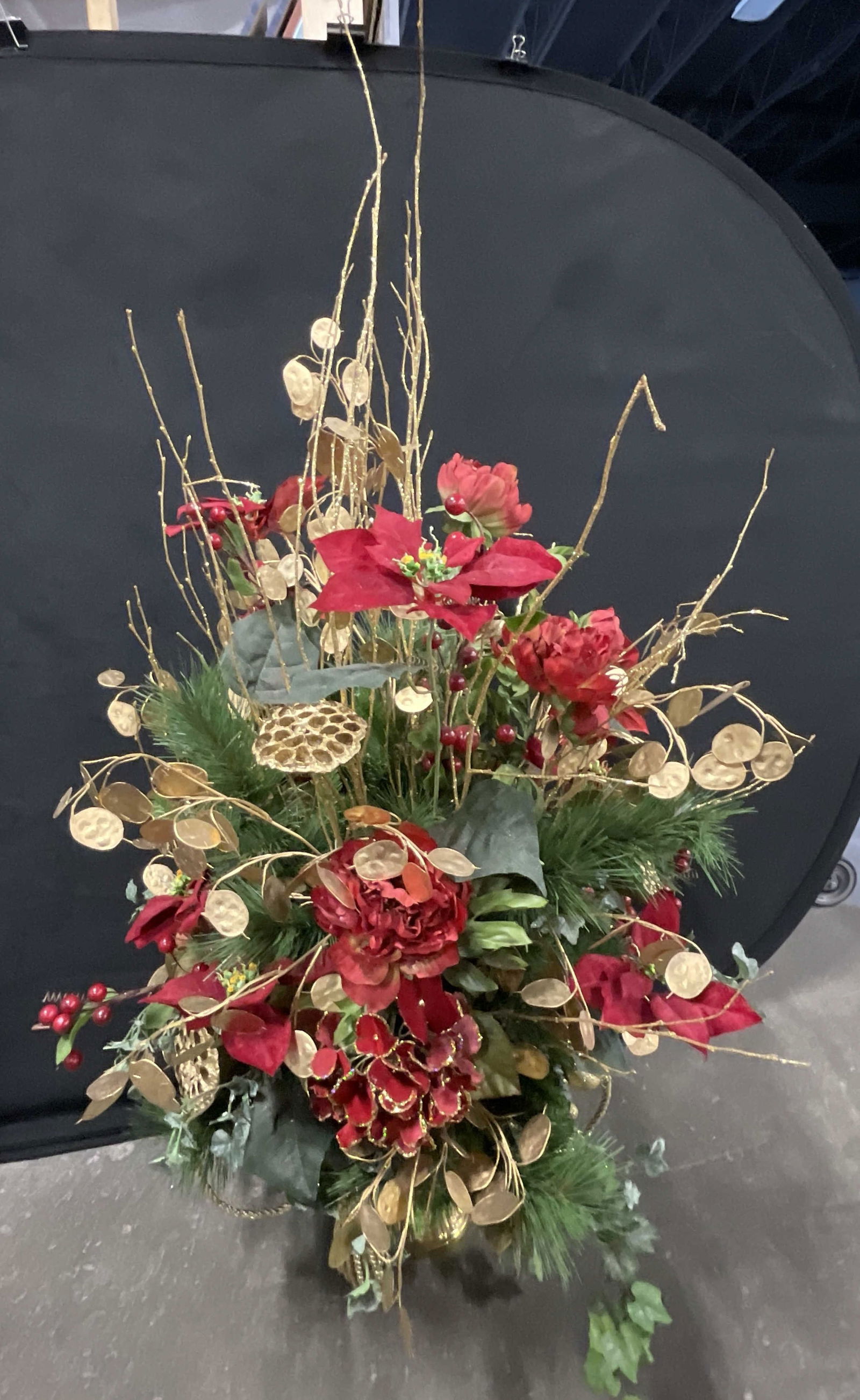 Faux Fruit & Foliage Display in Gold Tn Metal Urn: Faux Fruit & Foliage Display in Gold Tone Metal Urn. Includes red, green, and gold tone foliage. Crafted from plastic and fabric materials. Measures approx. 48H x 22W in. Surface wear and losses prese
