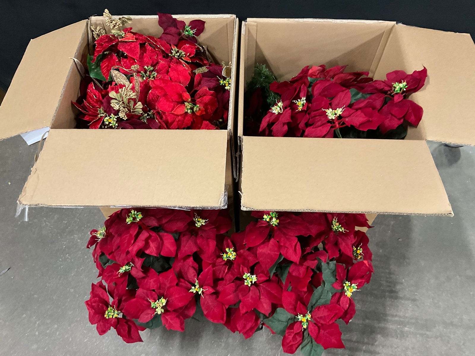 Group Lot Faux Poinsettia Arrangements: Group Lot Faux Poinsettia Arrangements. One pair measures approx. 24H x 14W in. The flowers are crafted from fabric and plastic materials. Not examined individually. Some surface wear, losses, and dis