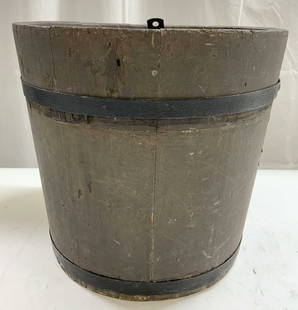 Antique Primitive Wooden bucket Vessel: Bucket is antique. Piece has black toned metal rings around structure. Bucket is brown toned and wooden. Piece has circular form rim. Antique primitive wooden bucket. Vessel measures approximately 11