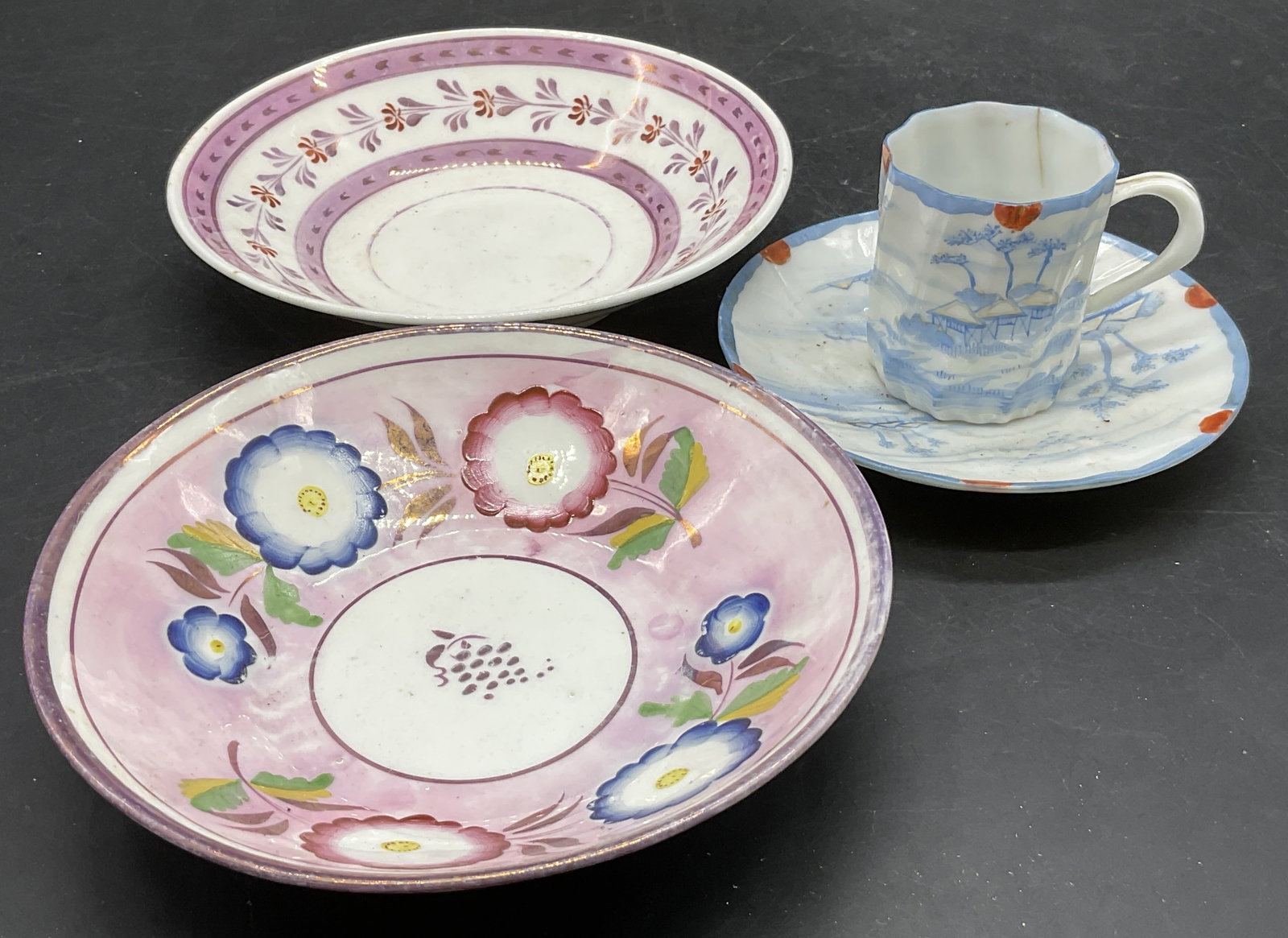 Lot 4 Vintage Porcelain Saucers & Teacup, Signed+: Three porcelain saucers and one porcelain demitasse teacup. Hand painted details to the pieces. The demitasse teacup and saucer set are signed on the undersides. The two larger pieces measure approx. 