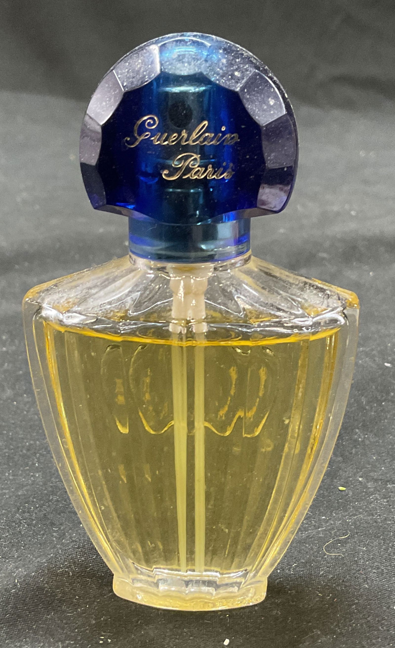 Guerlain SHALIMAR Eau de Toilette Perfume France: Guerlain SHALIMAR Eau de toilette perfume. Nearly full. Blue cap. Natural spray. 30 mL 1 Fl Oz. Made in France. 4 x 2.5 inches. Signed on underside. Some surface wear consistent with exposure. Guerlai
