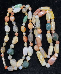 Lot 2 Semiprecious Gold Tone Beaded Necklaces: Lot of 2 multicolor semiprecious stone and gold tone beaded necklaces. Longer drop length approx 12.5 inches. Total weight of both necklaces 185.7 grams. Some wear including scratching observed. Jewel