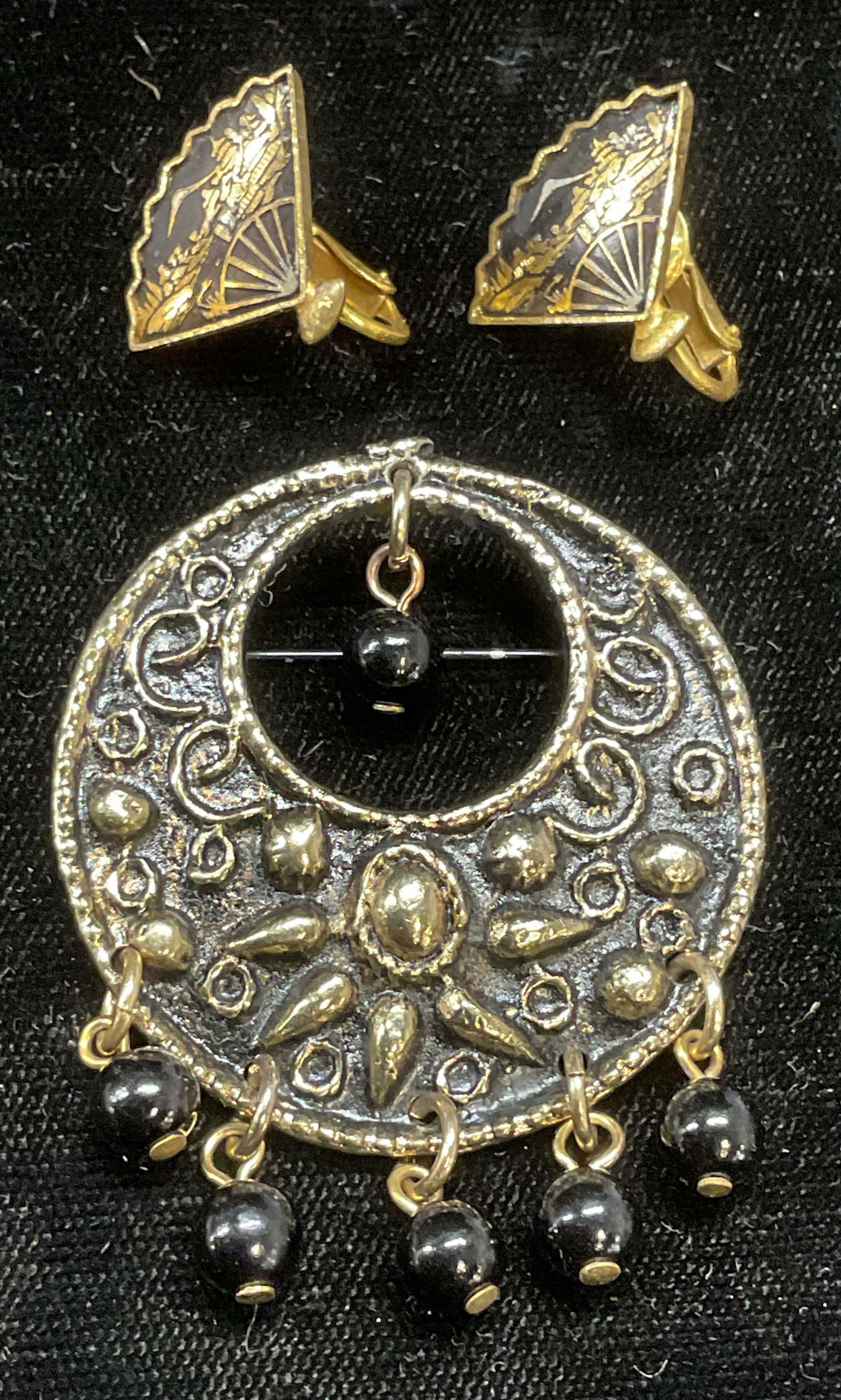 Lot 2 Gold Tn Fan Earrings, Silver Tn Brooch: Lot of 2 jewelry pieces. Gold tone and black enamel fan motif earrings and silver tone black beaded brooch. Larger piece measures approx 1 5/8 inches wide. Some wear including scratching observed. Jew