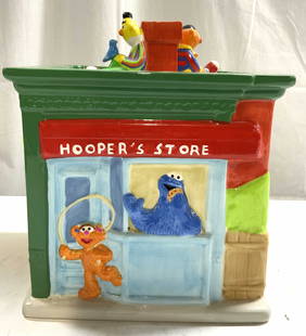 TREASURE CRAFT SESAME STREET Cookie Jar W Lid: Underside is marked TREASURE CRAFT SESAME STREET. Cookie jar is porcelain. Piece depicts Sesame Street characters Ernie & Bert sitting on top of the roof of Hoopers Store with other characters playing