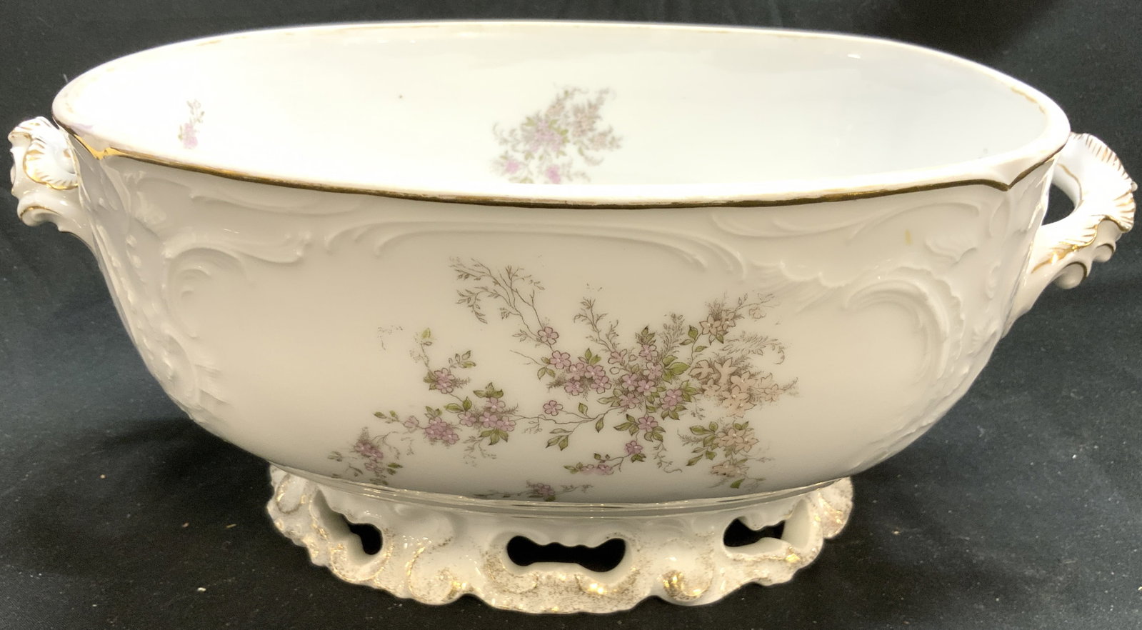 R&C SANSSOUCI Vtg Oval Porc Bowl W Handles: Underside is marked R&C SANSSOUCI. Bowl is white toned and porcelain. Piece has multi toned floral motif detailing. Bowl is oval form with handles at sides. Piece has pierced detail within footed base