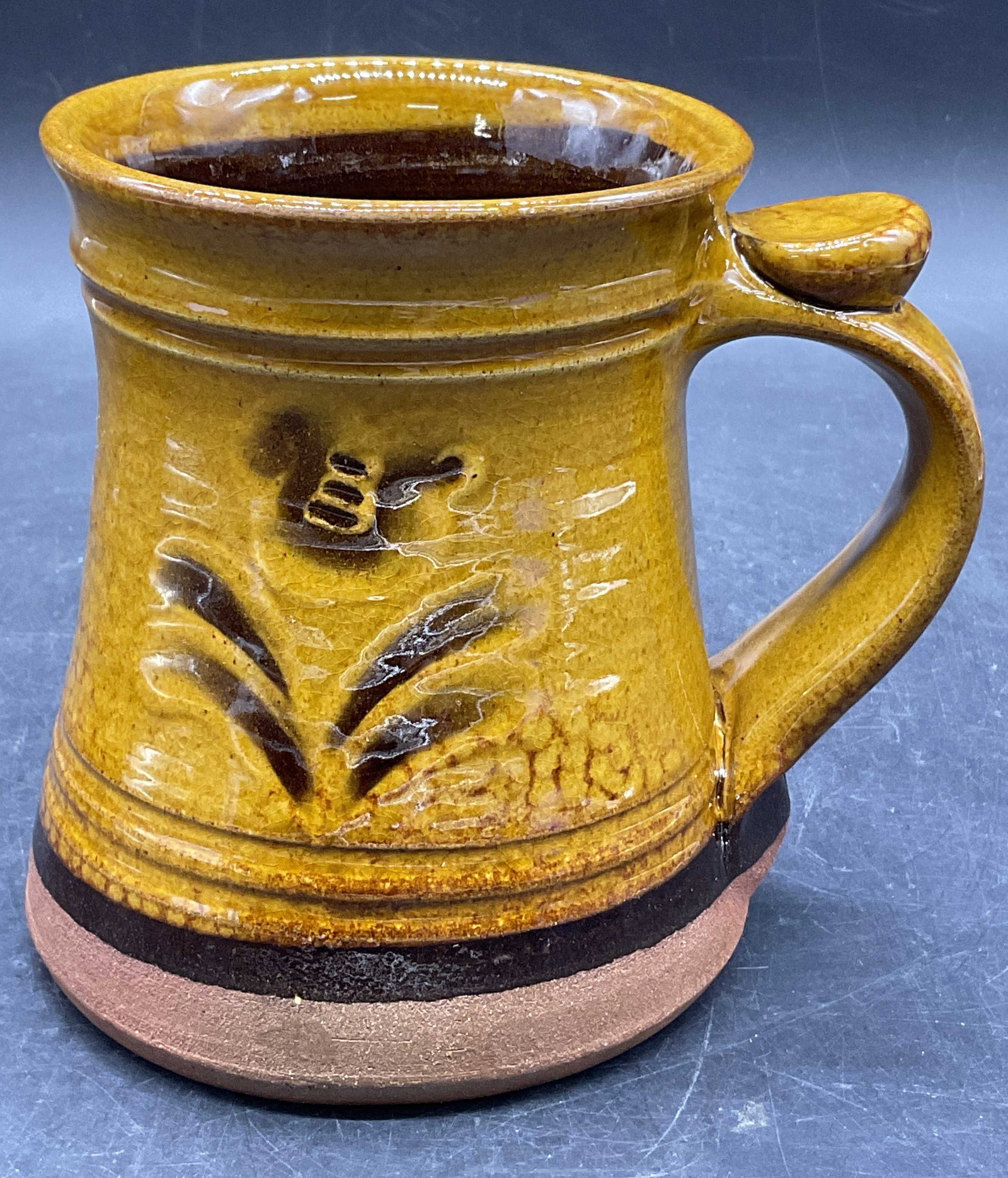 Trademarked Vintage Glazed Pottery Mug: Trademarked Vintage Glazed Pottery Mug. Floral motif to the obverse and reverse. Measures approx. 5H x 5.25W in. Surface wear, pitting, and crazing present. home decor, home accents, homewares, housew