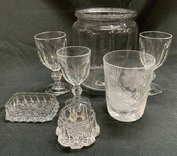 Lot 7 Gls & Crystal Tabletop Accessories, Heisey +: Lot includes 1 glass jar, 3 glass cordial glasses, 1 crystal cup, & 2 glass salt cellars. Cup has intricately cut floral and geometric detail. Undersides of cordials each appear to have letter H on un