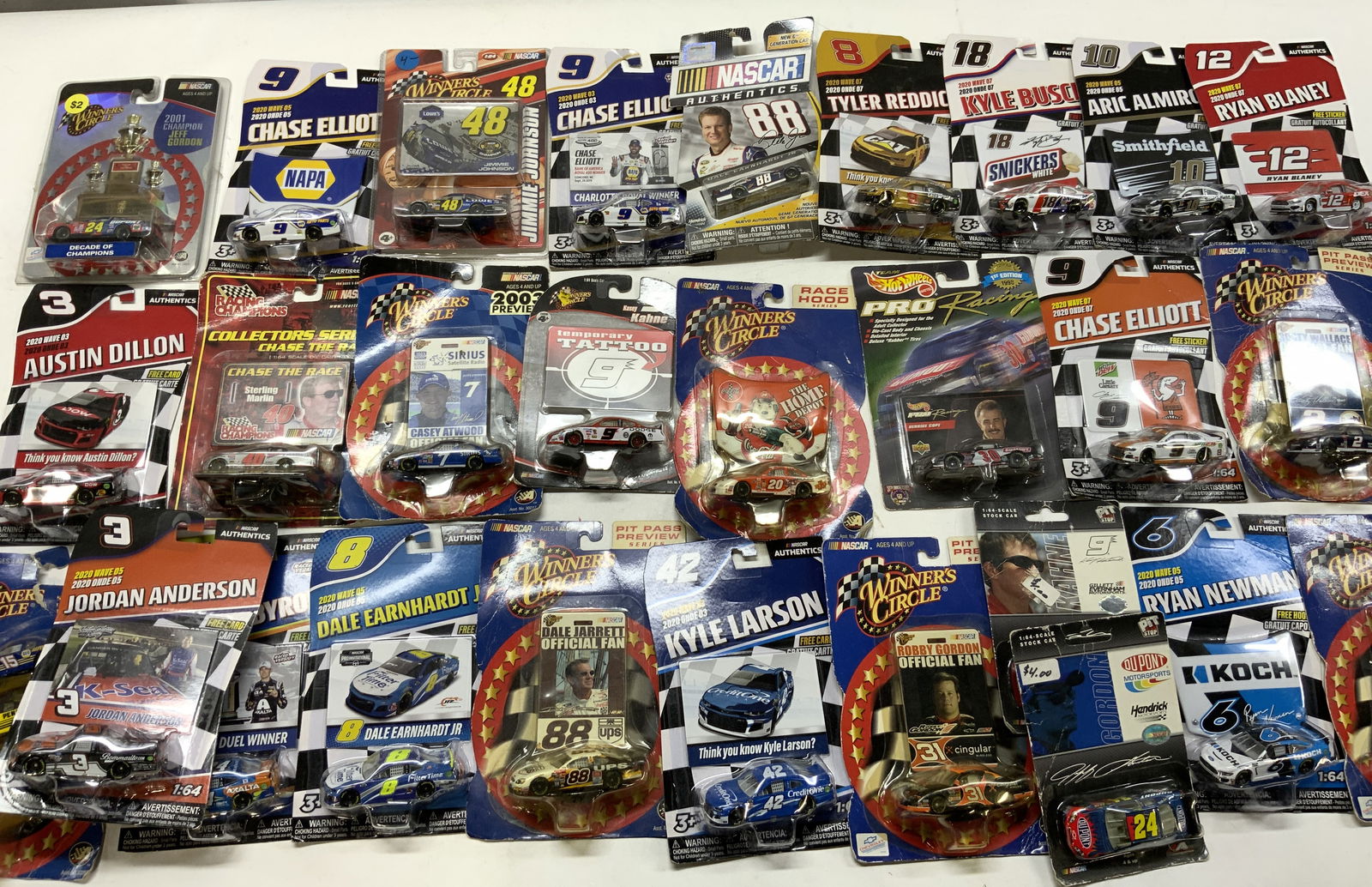 Lot 28+ 2000s Assorted NASCAR Collectible Cars NIP: Lot 28+ 2000s Assorted NASCAR Collectible Cars NIP Lot includes a big box of assorted NASCAR AUTHENTICS collectible cars. Cars are BRAND NEW IN PLASTIC. Signed & marked. Surface wear consistent to age