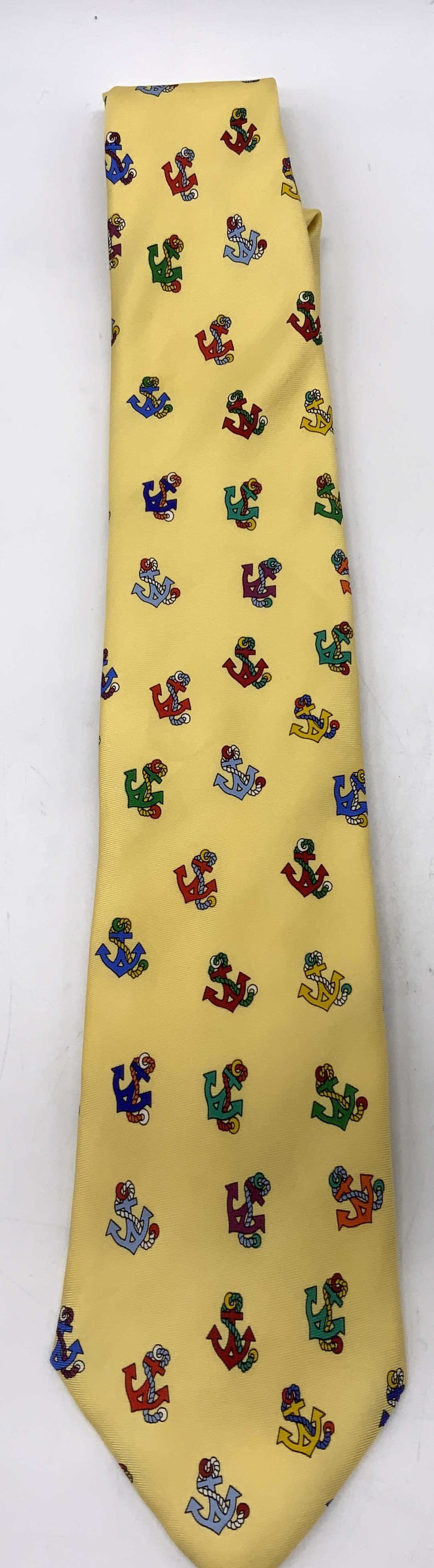 ALYNN NECKWEAR Yellow Anchor Pattern Silk Necktie: ALYNN NECKWEAR Yellow Anchor Pattern Silk Necktie Necktie features a vibrant yellow tie with a colorful anchor pattern. Signed & marked reads, ALYNN NECKWEAR, STAMFORD CT. Surface wear consistent to a