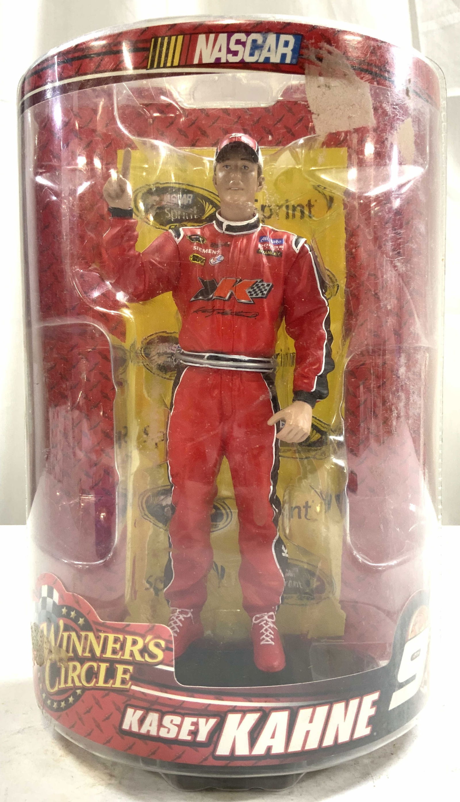 KASEY KAHNE Winners Circle NASCAR Driver Fig NIP: Packaging reads KASEY KAHNE 9 WINNERS CIRCLE. Figure depicts NASCAR driver Kasey KAHNE. Dressed in a red toned racing suit with numerous sponsors. Figure is within plastic packaging. Packaging measure
