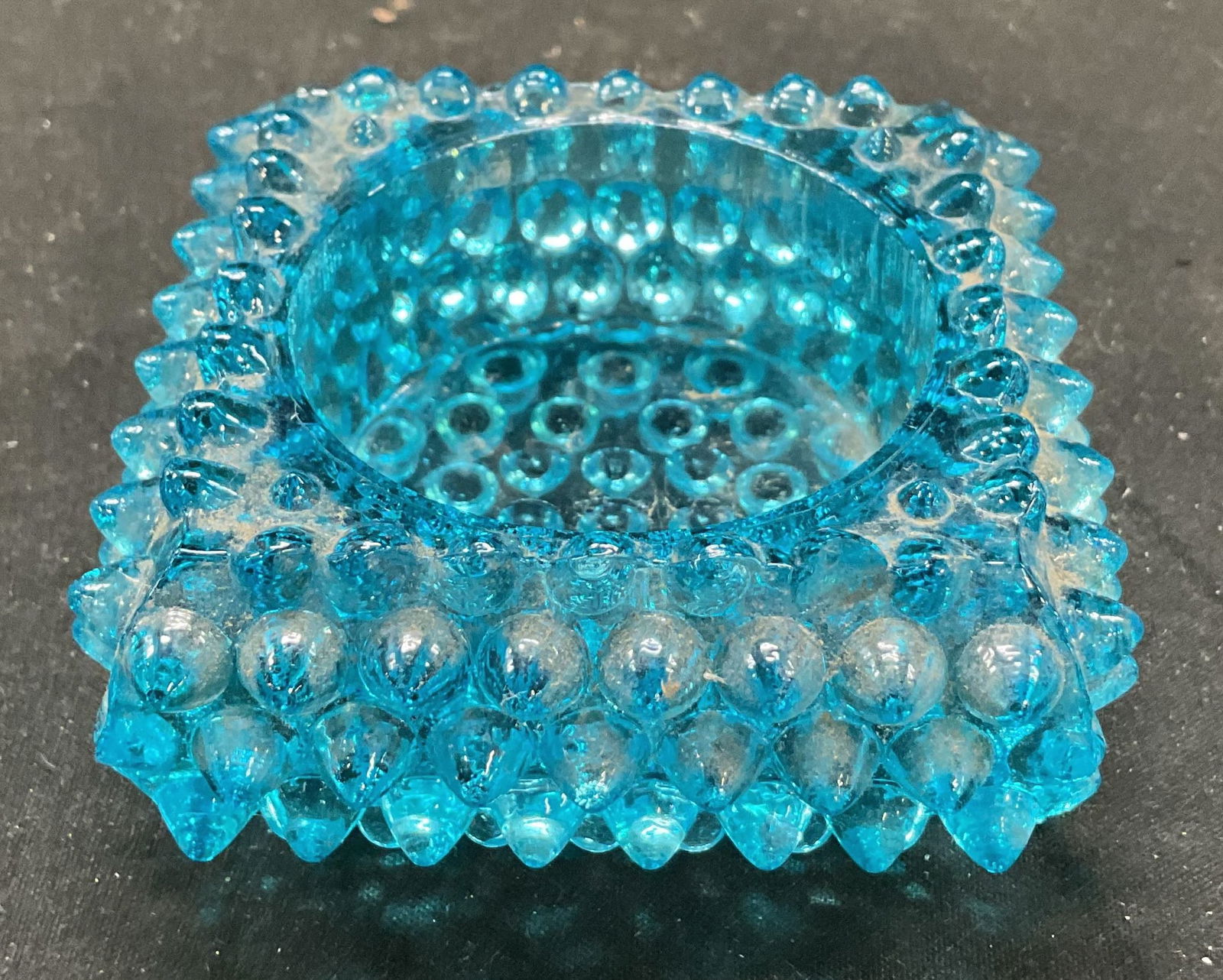 Vtg Fenton Hobnail Aqua Blue Votive Candle Holder: Vintage Fenton Hobnail Aqua Blue Votive Candle Holder. Glass candle holder, Ashtray, salt cellar. 3 x 1 inches. Some surface wear consistent with exposure. Fenton, hobnail, aqua blue candle holder, ca