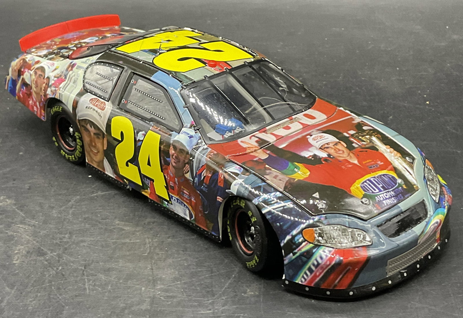 ACTION Jeff Gordon #24 Monte Carlo NASCAR Model: Die cast replica of Jeff Gordons # 24 Monte Carlo NASCAR race car, specifically a 2005 Milestones edition commemorating his 1994 Charlotte Win. Underside of the car reads ACTION. Measures approx. 2.25