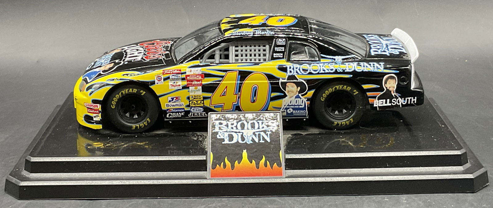 #40 Coors Light Chevrolet NASCAR Model Car, Stand: Die cast model of the #40 Coors Light / Brooks & Dunn Chevrolet Monte Carlo driven by Sterling Marlin in the 1999 NASCAR Winston Cup Series. Car appears to be affixed to the black plastic stand. The s