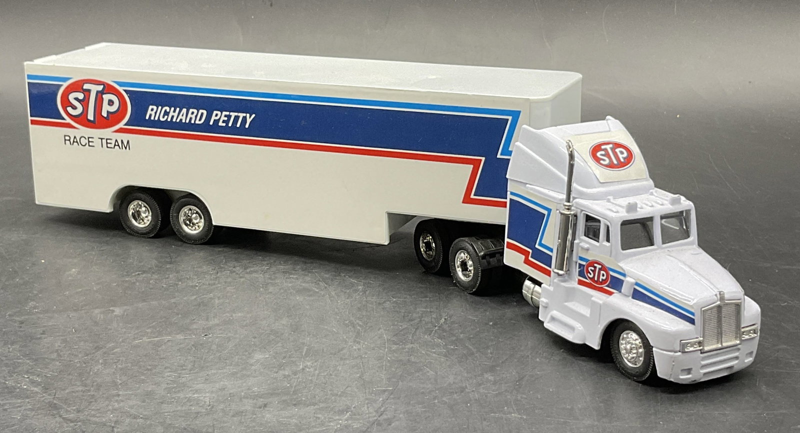 1991 Racing Champions Petty NASCAR Hauler Model: 1991 Racing Champions die cast transporter truck / hauler featuring NASCAR STP RICHARD PETTY RACE TEAM LOGO. Underside reads 1991 Racing Champions. The obverse can be removed from the bed of the truck