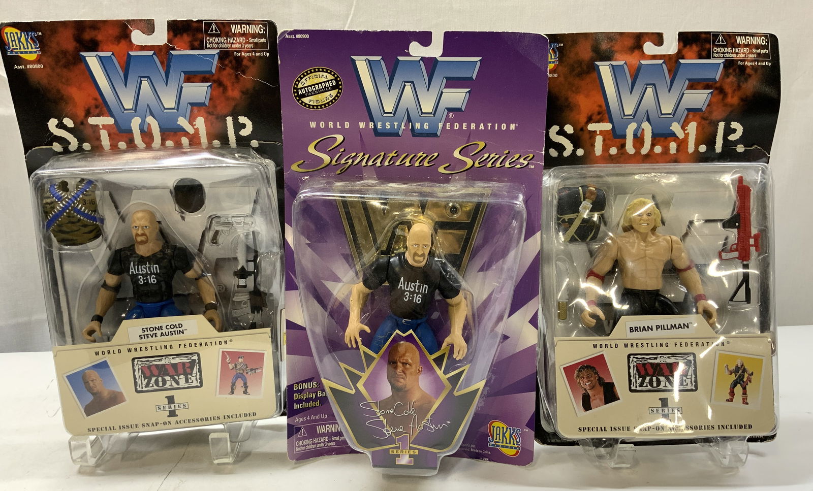 Lot 3+ 1997 JAKS War Zone Ser 1 Action Figures NIP: Lot 3+ 1997 JAKS War Zone Ser 1 Action Figures NIP 3 NEW IN PLASTIC action figures. Figures depicting, Brian Pillman & Cold Steve Austin. SERIES 1. Surface wear consistent to age, use & exposure. Meas