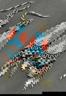 Handmade Turquoise Blue Beaded Metal Earrings: Handmade Turquoise Blue Beaded Metal Drop Earrings. Turquoise blue, red, and black composite beads to the piece. Crafted from metal, beads, and composite materials. Fishhook backings. Measures approx.