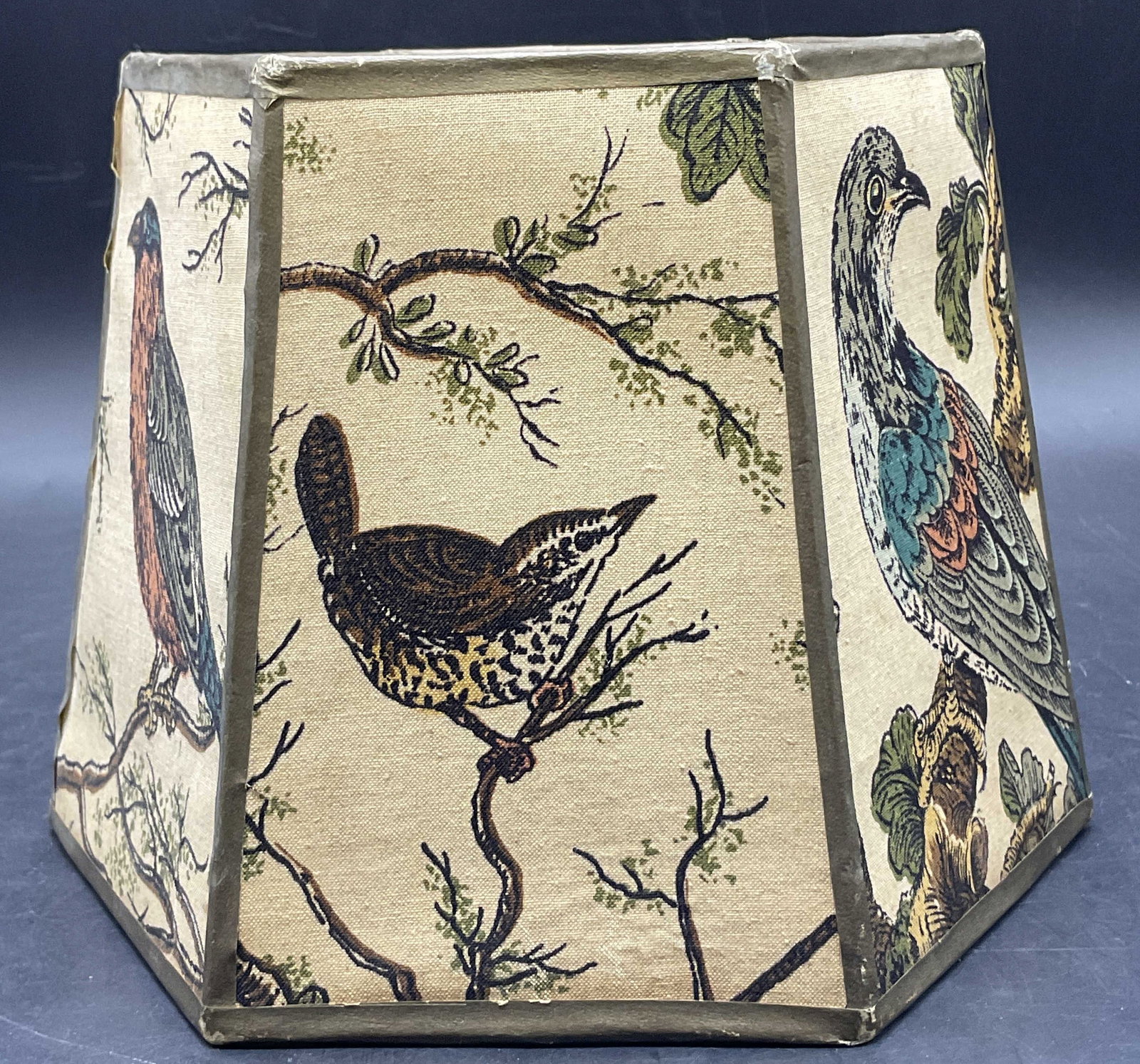 Vintage Hexagonal Bird Motif Lamp Shade: Vintage Hexagonal Bird Motif Lamp Shade. Crafted from fabric, paper, and metal materials. Measures approx. 6H x 8W in. Width measured at widest point. Losses to material, surface wear, and discolorati