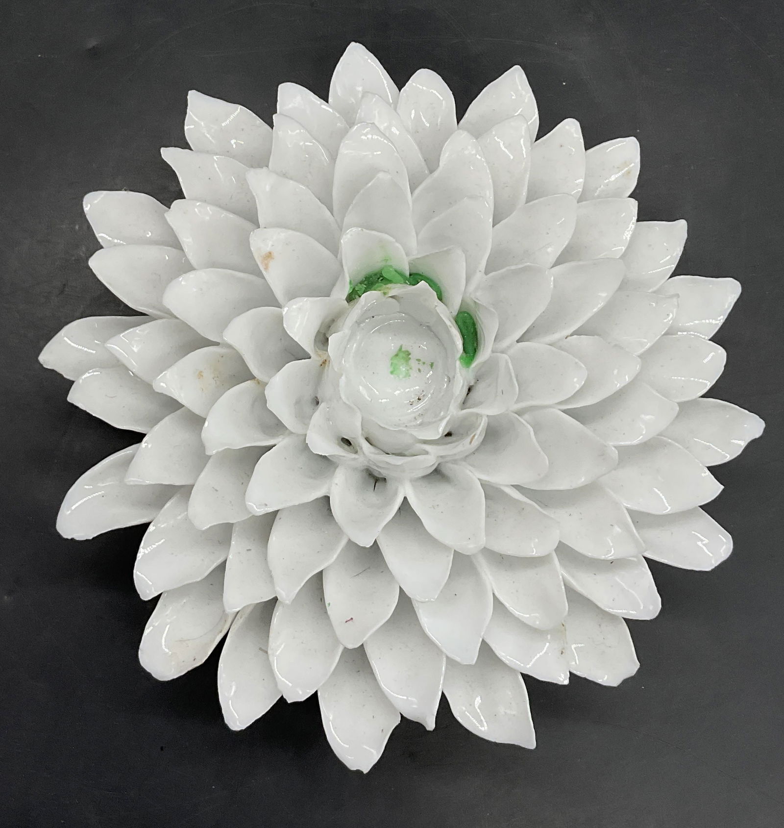 WHAT A STORE White Ceramic Floral Candleholder: WHAT A STORE White Ceramic Floral Candleholder. Raised petals throughout. Tag to underside reads WHAT A STORE. Measures approx. 3H x 7W in. Surface wear, chipping, and residue present. home decor, hom