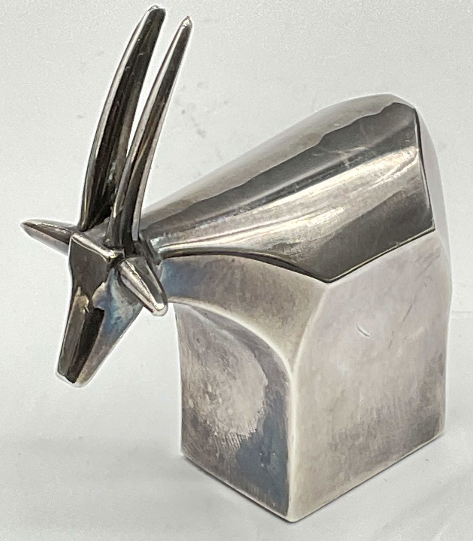 DANSK DESIGNS Silver Plated Gazelle Paperweight: DANSK DESIGNS Vintage Silver Plated Gazelle Paperweight. Underside signed DANSK DESIGNS, JAPAN, EP ZINC. Crafted from silver plated zinc. Measures approx. 2.5H x 2.25W in. Measured at widest point. Su