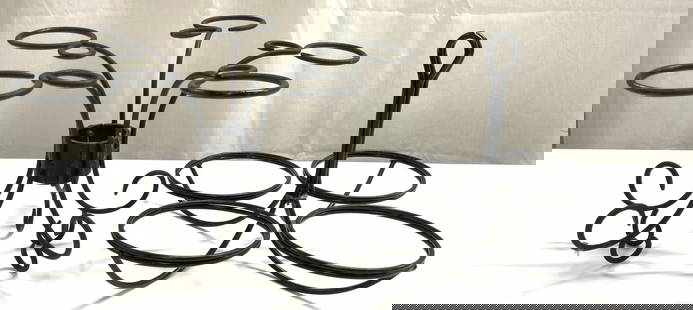 Lot 2 Metal Serving Rack & Candle Holder: Lot includes 1 serving rack and 1 five arm candle holder. Each piece is black toned and metal. Candle holder has curled feet. Serving rack has handle in center. Candle holder measures approximately 7.
