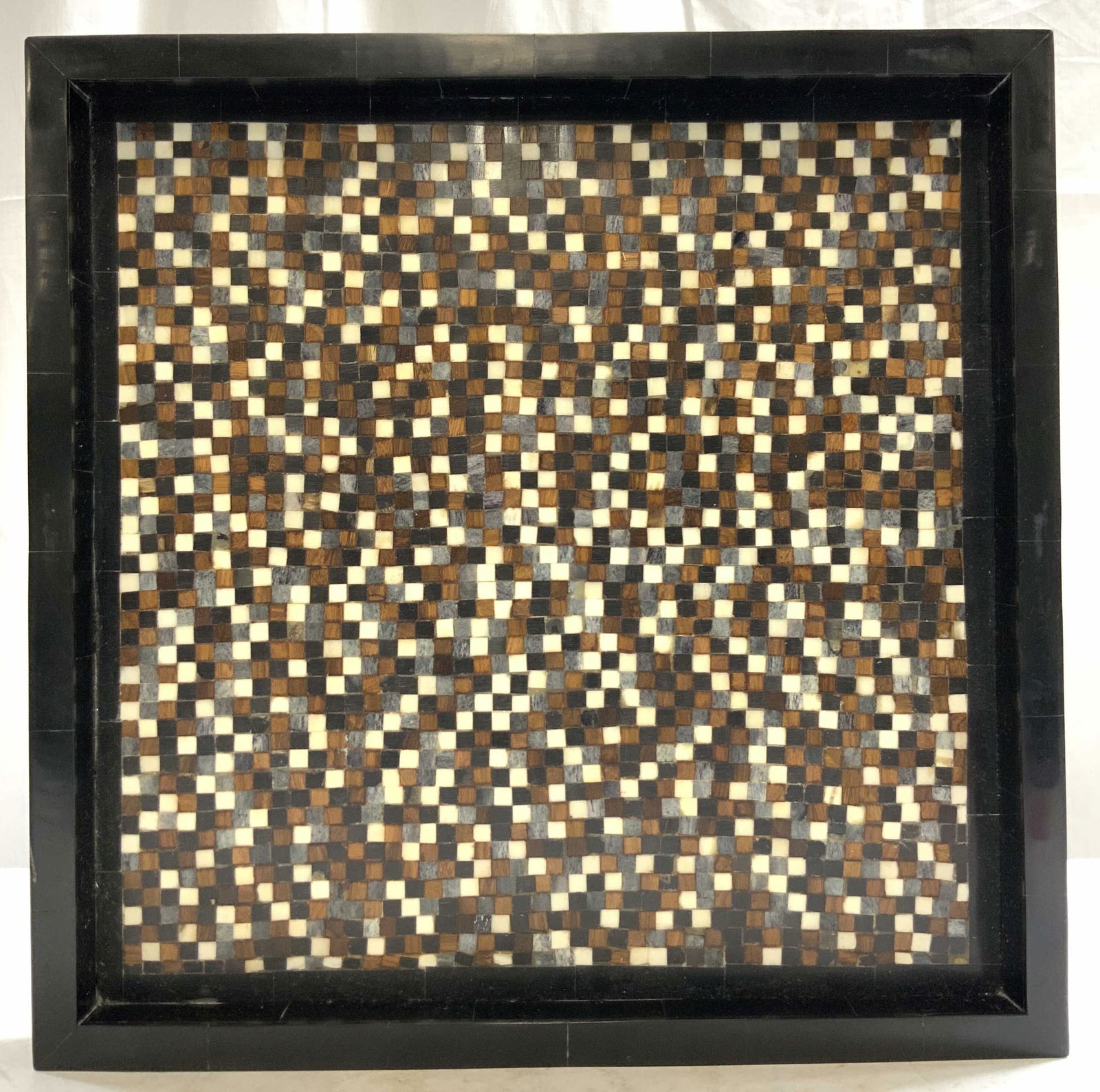 GLOBAL VIEWS Inlaid Wood & Bone Tray India: Tag on underside reads GLOBAL views India. Tray is black, appears to be composite with inlaid wooden & bone checkered detail. Tray has raised edges. Piece has square form. Measures approximately 14 in