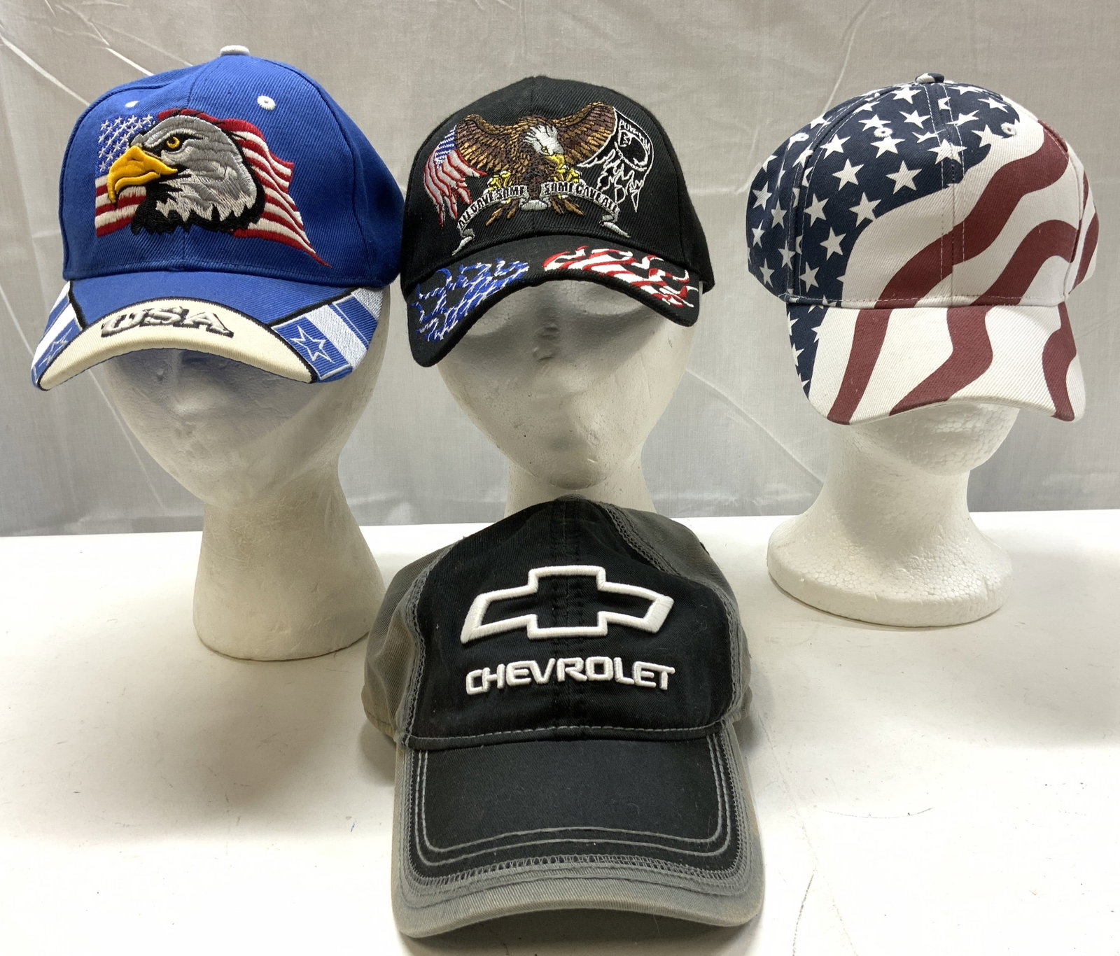 Lot 4+ Patriotic American & Chevrolet Hats: Lot 4+ Patriotic American & Chevrolet Hats Lot includes hats that feature USA flags, bald eagles & the logo CHEVROLET. Hats have an adjustable strap. Surface wear consistent to age, use & exposure. Pa