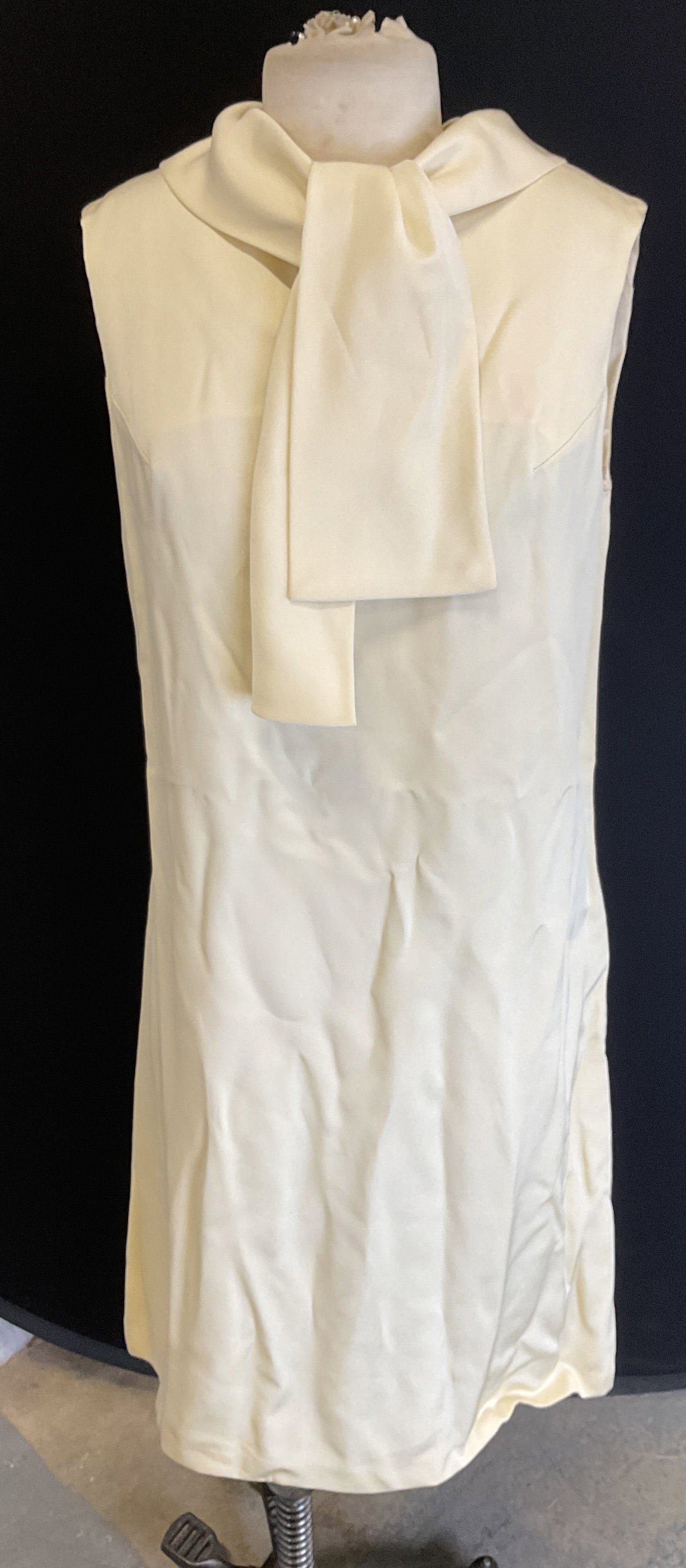 Vintage White Sleeveless Sheath Dress: Vintage white sleeveless sheath dress with tie collar. Mid length. Measures approx 18 inches across chest. Back zipper. Synthetic material. Fabric has no stretch. Some wear including blemishes. Dress,