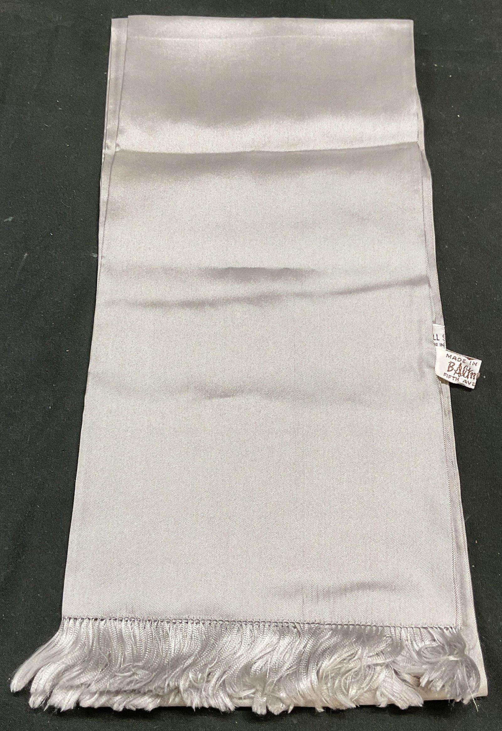 Vtg B Altman Silver Silk Fringe Scarf: Vintage B Altman silver scarf with fringe trim. Silk. Measures approx 50 inches long. Some wear consistent with exposure. B Altman, b Altman scarf, vintage scarf, designer scarf, designer accessories,