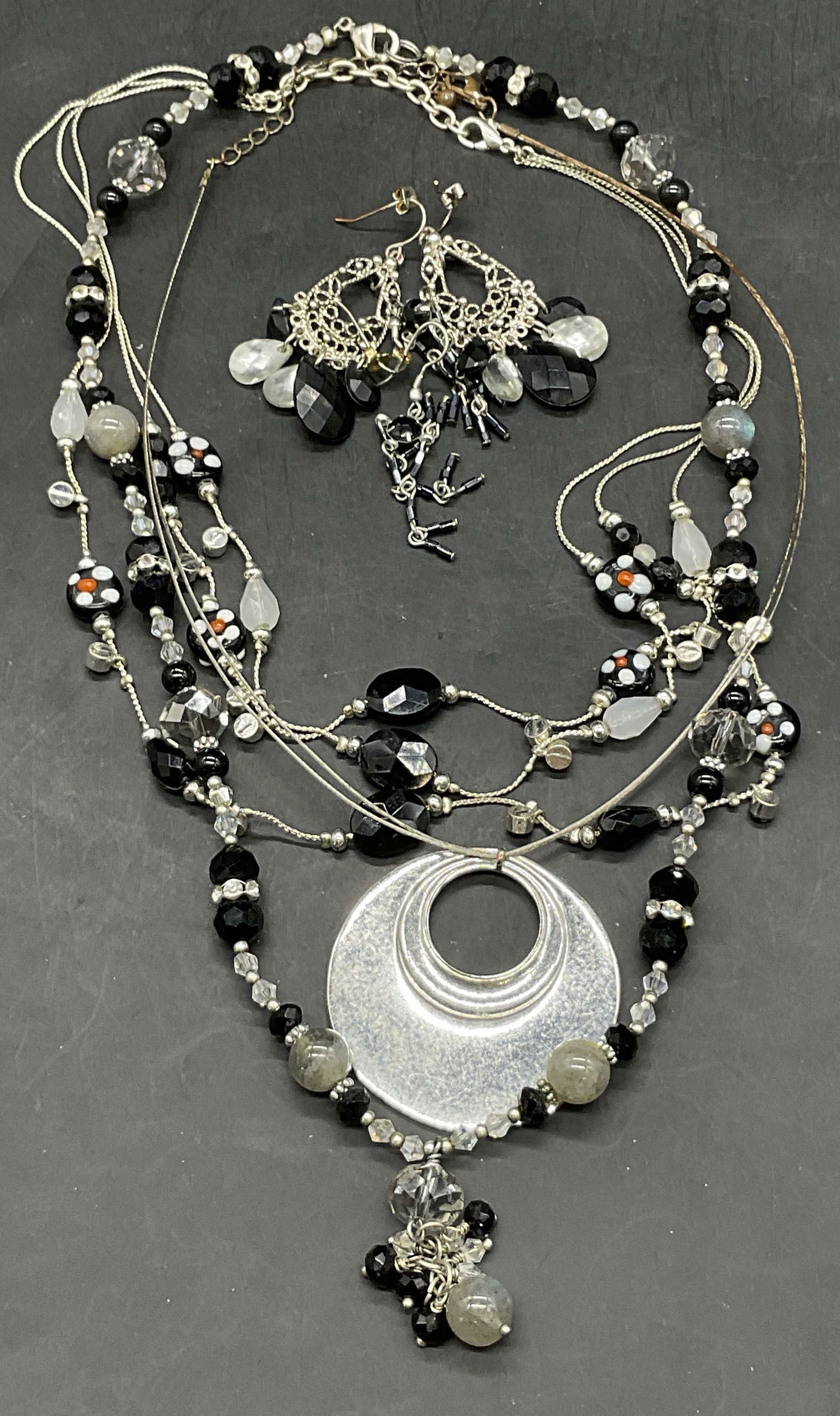 Lot 5 Vintage Silver Tone Metal Beaded Jewelry: Three necklaces and two pairs of earrings. Crafted from silver tone metal and beads. Backings for pierced ears. Necklaces have clasp closures. Longest necklace measures approx. 20 inches in length. Th