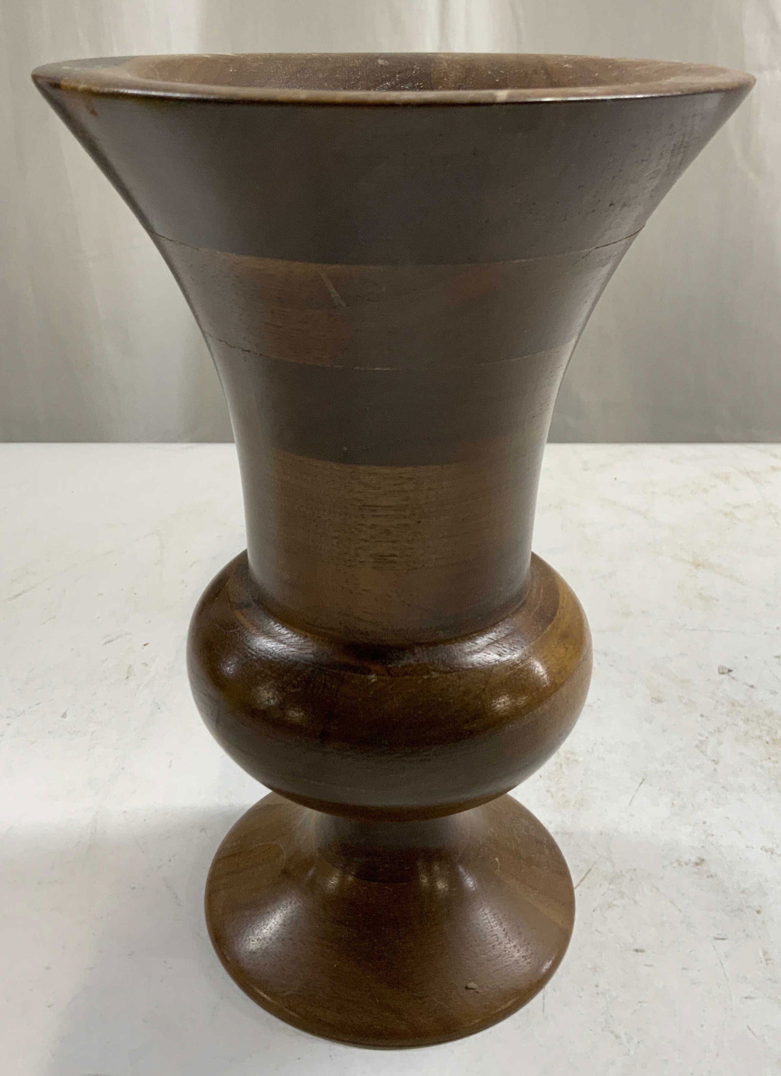 Vntg Natural Wood Footed Walnut Vase: Vase is brown toned and wooden. Piece appears to be walnut. Vessel is footed. Piece has circular form base . Measures approximately 8.5 inches tall 5.5 inches wide. Vase, vessel, wooden vase, footed v