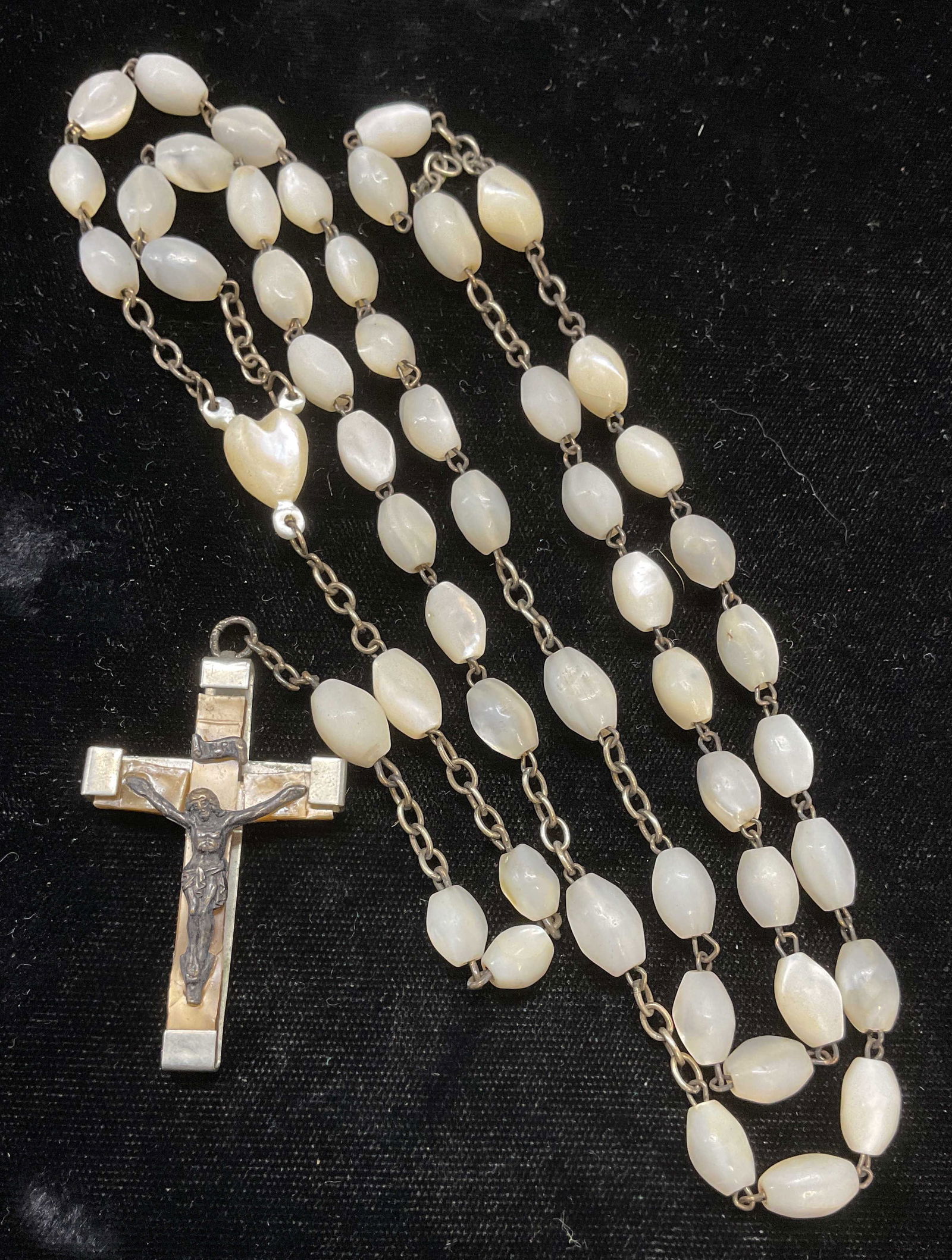 Mother of Pearl Rosary Bead Necklace, France: Vintage mother of pearl rosary beads with crucifix pendant. Silver tone metal with image of Christ on cross. Made in France. Drop length approx 14 inches, total drop approx 21.5 inches. Includes box.