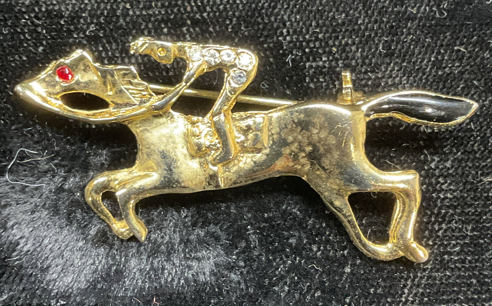 Signed HJ Gold Tn Crystal Horse Brooch: Signed HJ gold tone equestrian horse motif brooch. Measures approx .75 x 1.75 inches. Some wear including scratching observed. Jewelry, estate jewelry, costume jewelry, cocktail jewelry, fashion jewel