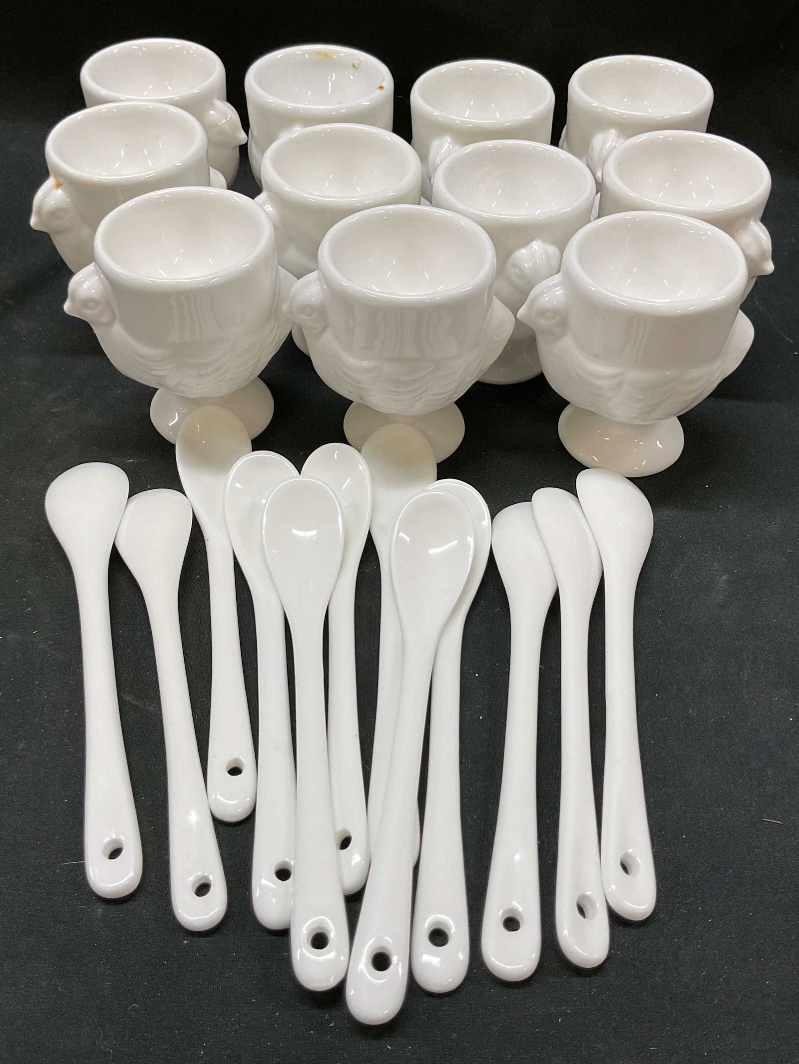 Lot 11 White Porcelain Hen Egg Cups Spoons: Lot 11 white porcelain hen egg cups and spoons. Lot includes 11 Egg cups, 12 Coffee Spoons. Glossy porcelain material, hen shaped design. Coffee spoons for espresso, tea, sauces, and desserts. Cup mea