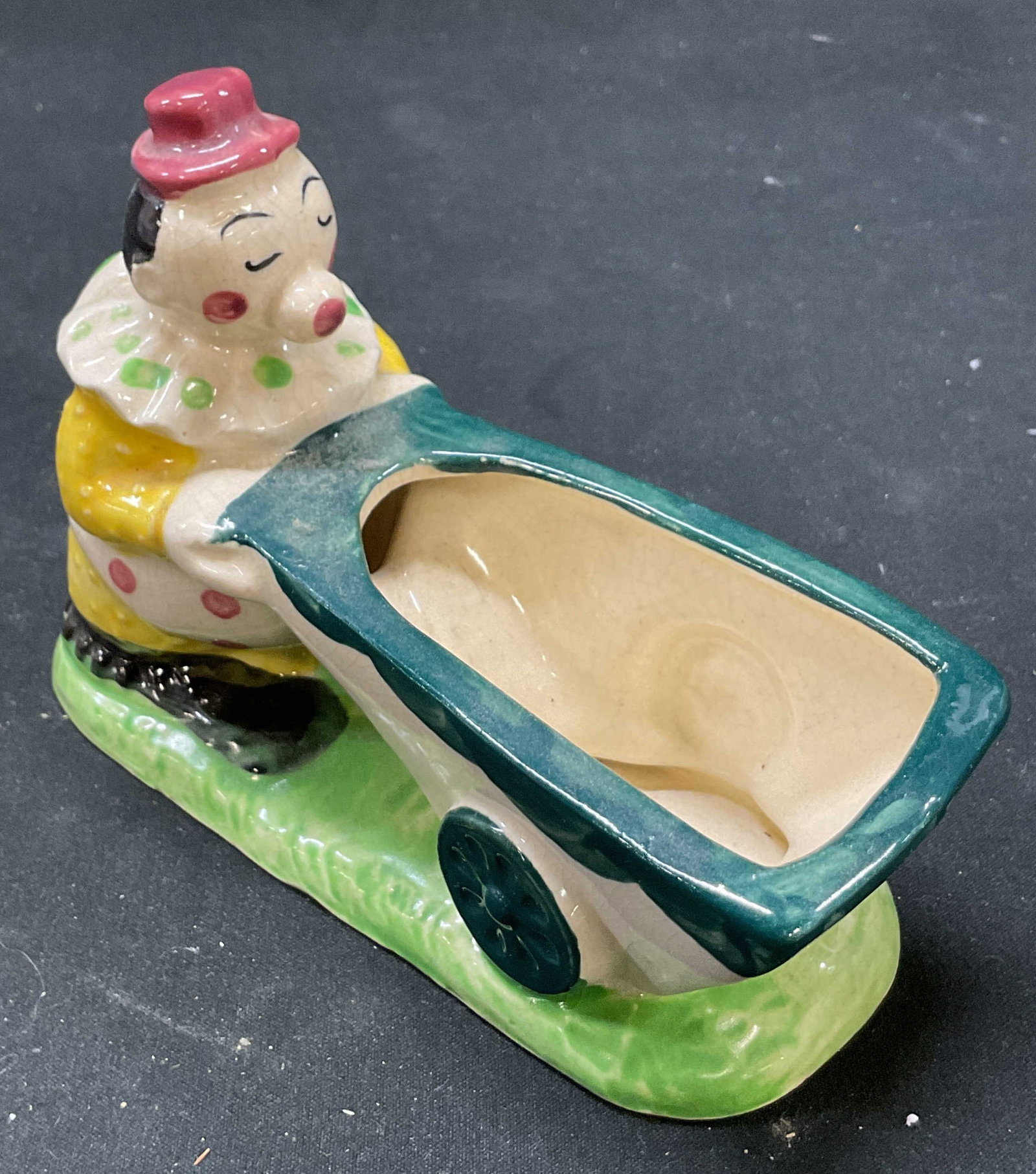Vtg Pioneer Pottery NEW YORK Circus Clown Planter: Vintage pioneer pottery New York circus clown planter. Circus clown and wheelbarrow. Hand painted planter. 5 x 4 x 2 inches. Some surface wear consistent with exposure. Singed on underside. Made in Ja