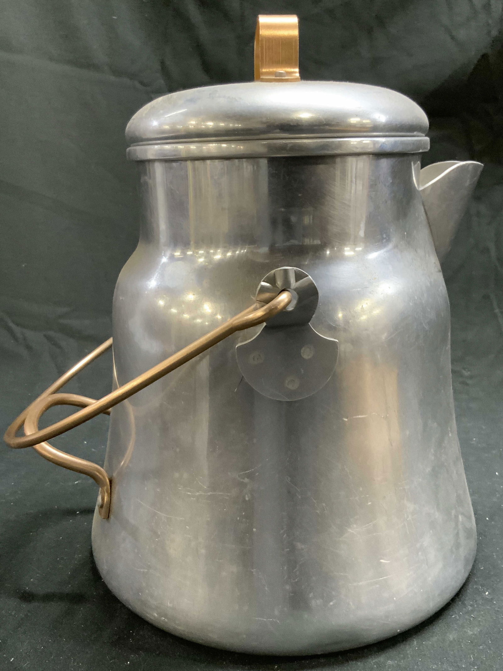 TACUCO ALUMINUM Teapot W Lid & Handle: Underside is inscribed TACUCO ALUMINUM MADE IN USA. Teapot is silver and copper toned. Piece includes lid. Teapot also has arch form handle and handle at side. Possibly vintage. Teapot measures approx
