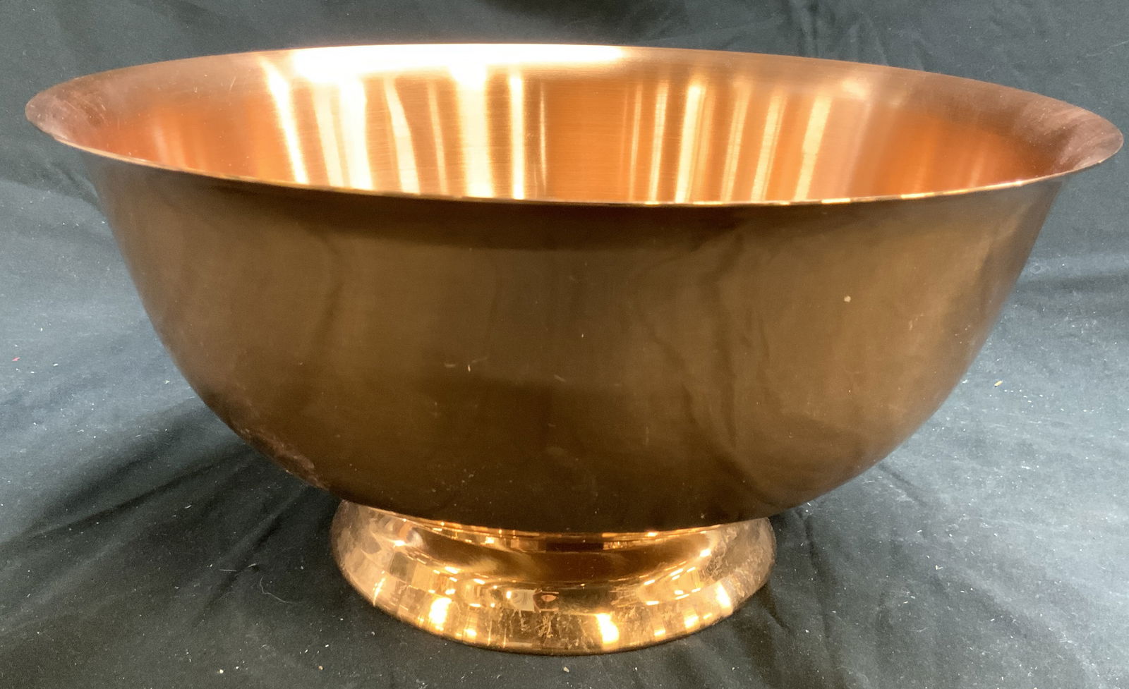 CG Footed Brushed Copper Bowl: Underside is inscribed CG. Bowl is brushed copper. Piece is footed. Base has circular form. Rim leans outward slightly. Vessel measures approximately 12.25 inches diameter 6 inches tall. Bowl, copper