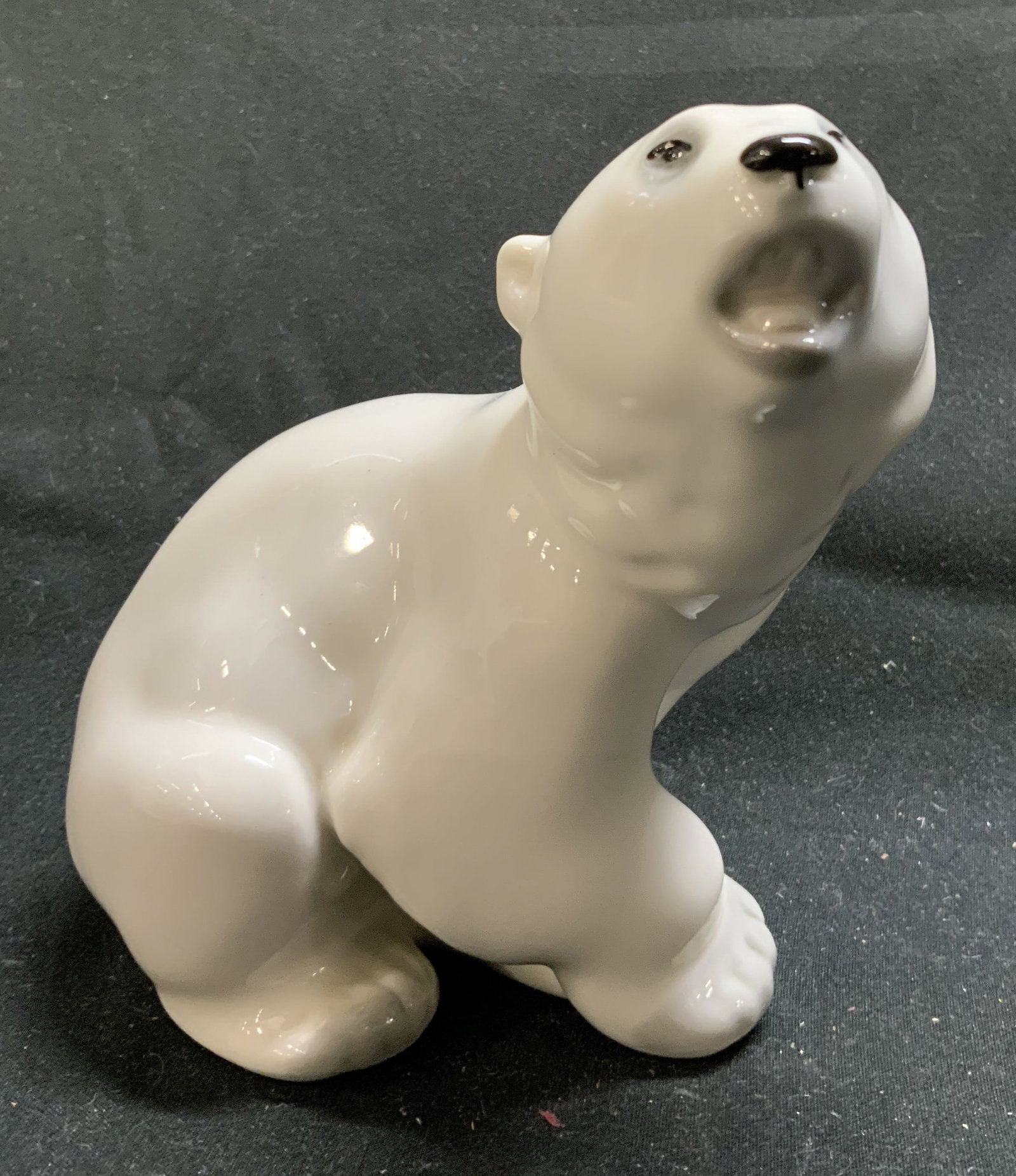 Porcelain Polar Bear Baby Cub Figurine: Porcelain Polar Bear Baby Cub Figurine Figurine depicting a glossy white porcelain polar bear cub. Surface wear consistent to age, use & exposure. Measurements: length 2.7in x width 2.4in x height 4.8
