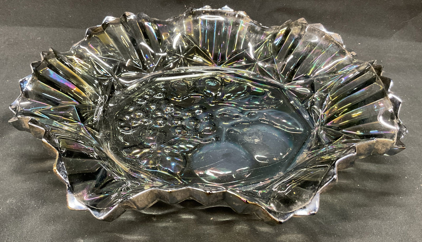 Vtg Federal Carnival Glass Pioneer Fruit Bowl: Vintage federal carnival glass pioneer fruit bowl. Smoke colored glass with iridescent carnival finish. Embossed fruit design in center. Crimped or ruffled edges and pleated ruffled border. 10 x 2 inc