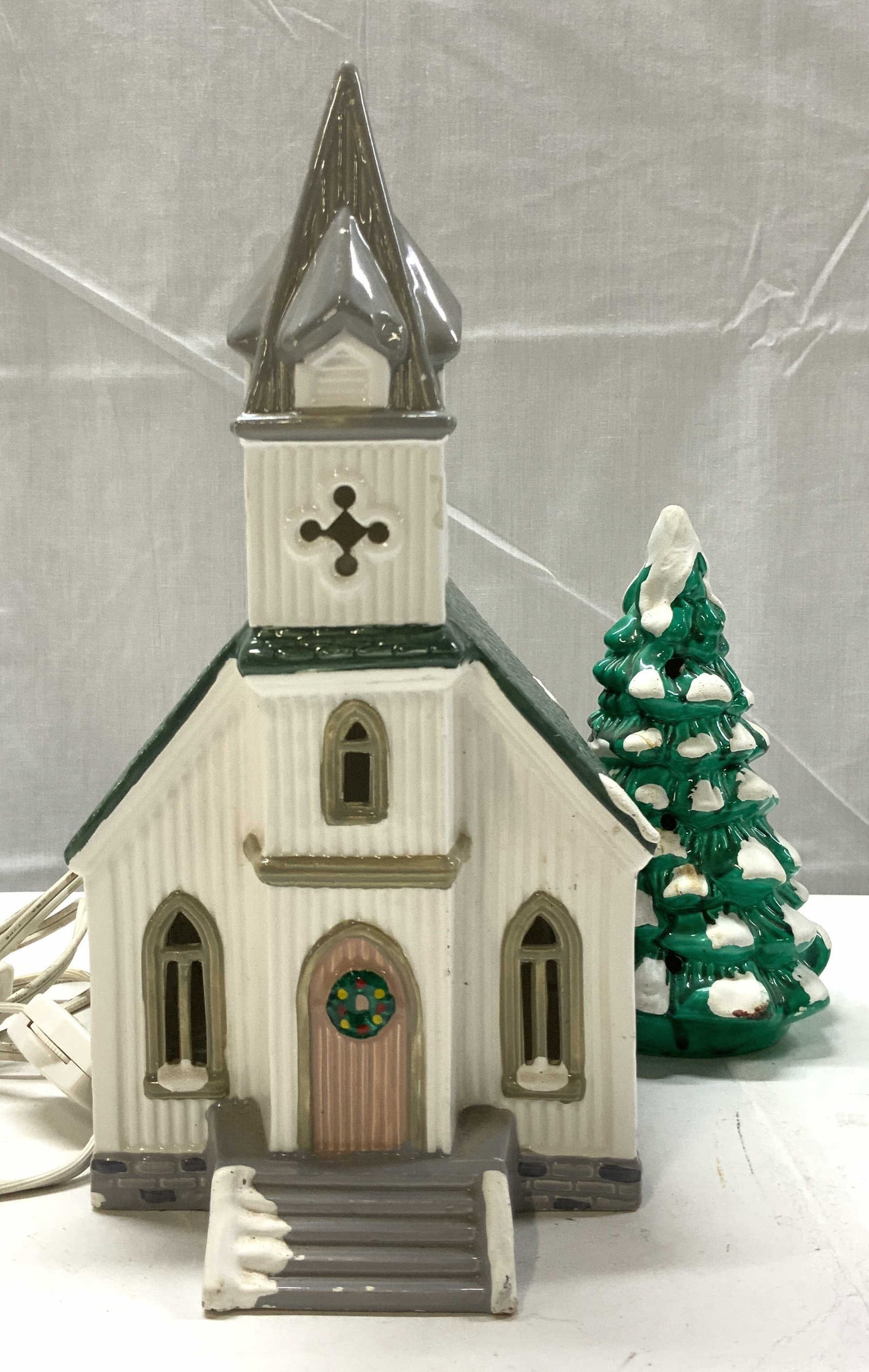 DEPARTMENT 56 Snow Village All Saints Church: DEPARTMENT 56 Snow Village All Saints Church Piece depicts a ceramic church with a green roof & snow-covered steps. Comes with cords but not tested for functionality. Surface wear consistent to age, u