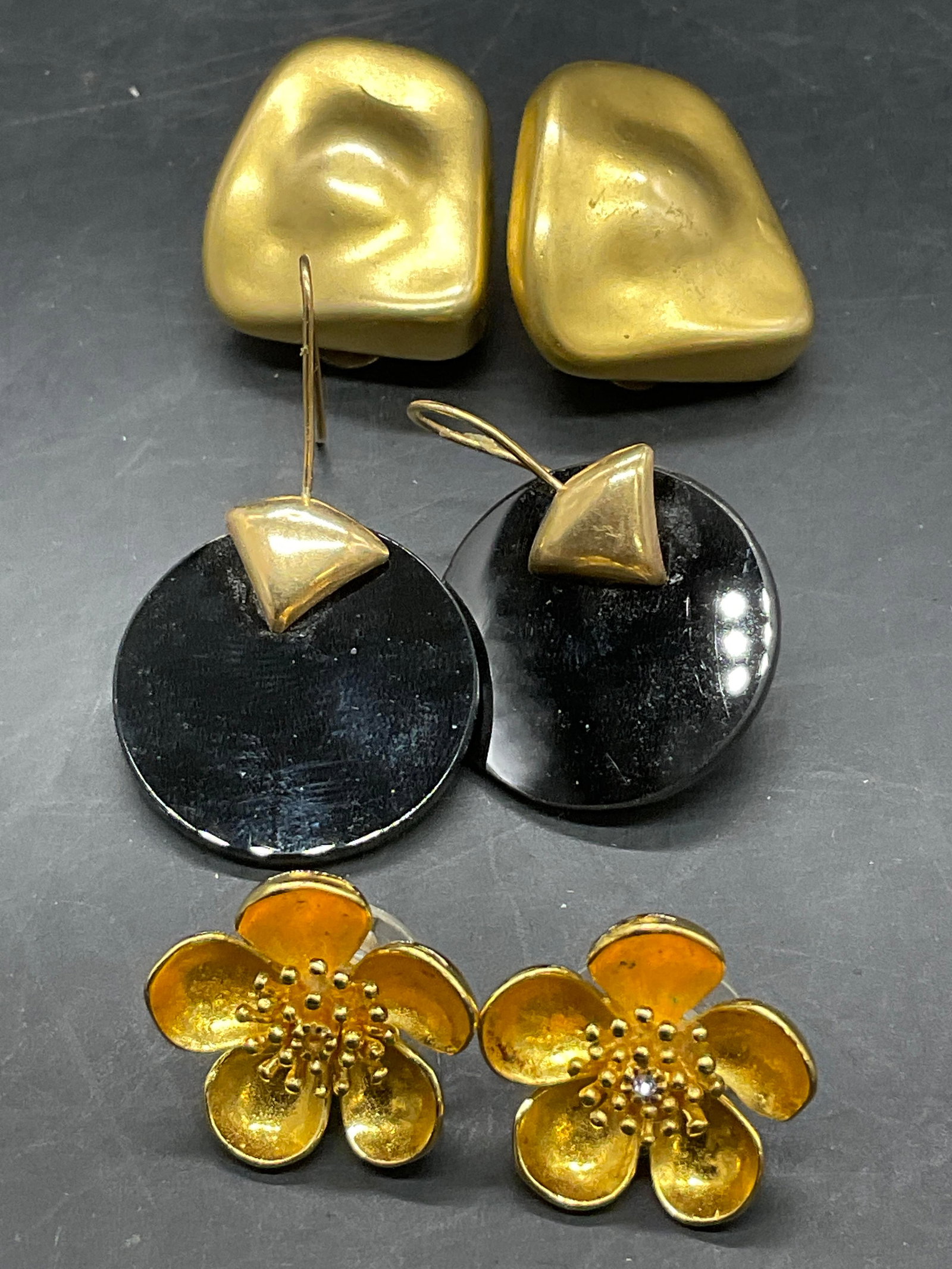 Lot 3 Vintage Gold Tn Metal Earrings, MMA RC USA +: Three pairs of vintage gold tone metal earrings. Two pairs have backings for pierced ears and one has clip on backings. Crafted from gold tone metal and composite materials. The floral form earrings a
