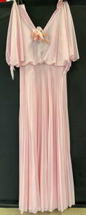 Vtg Pink Polyester Pleated Maxi Dress: Vintage pink pleated maxi dress. Pink pleated dress with floral attachment at chest. Material tag not attached, appears to be polyester or polyester synthetic mix. Back zipper and clasp. 13 inches acr