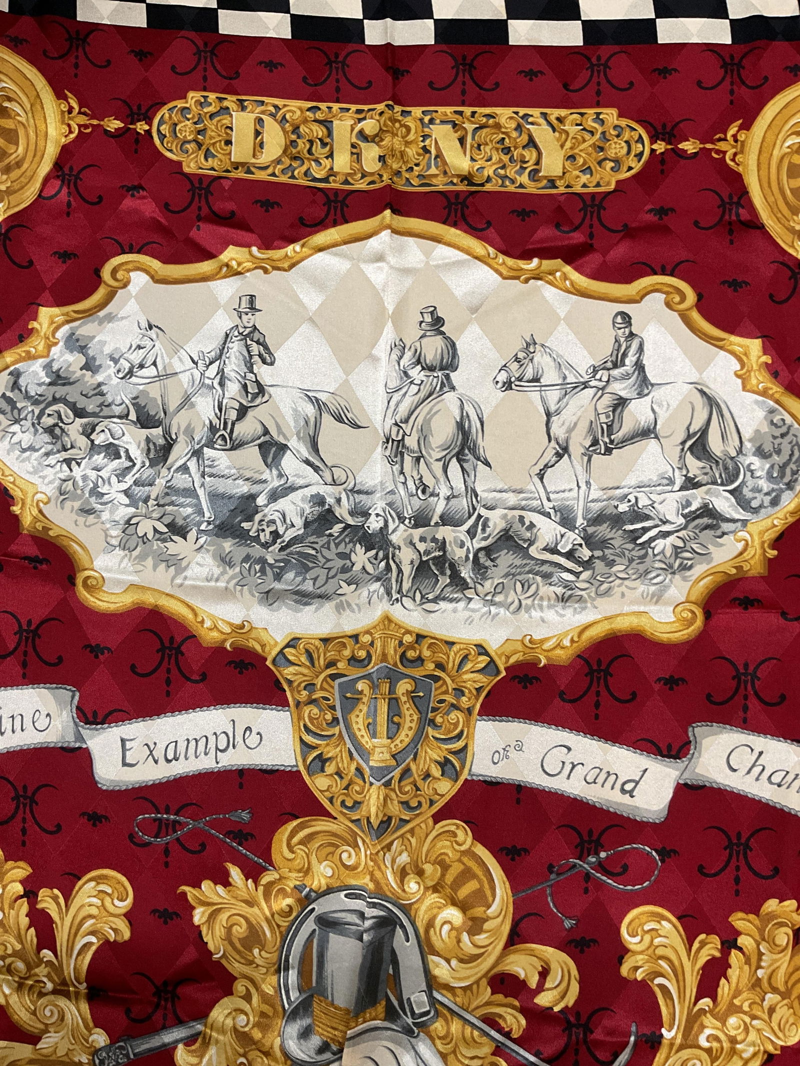 DKNY Red Silk Hunting Scene Scarf, Italy: DKNY red black and gold silk scarf with hunting scene print. Made in Italy. Measures approx 34 x 34 inches. Some blemishes observed. DKNY scarf, designer scarf, silk scarf, red scarf, hunting scene sc