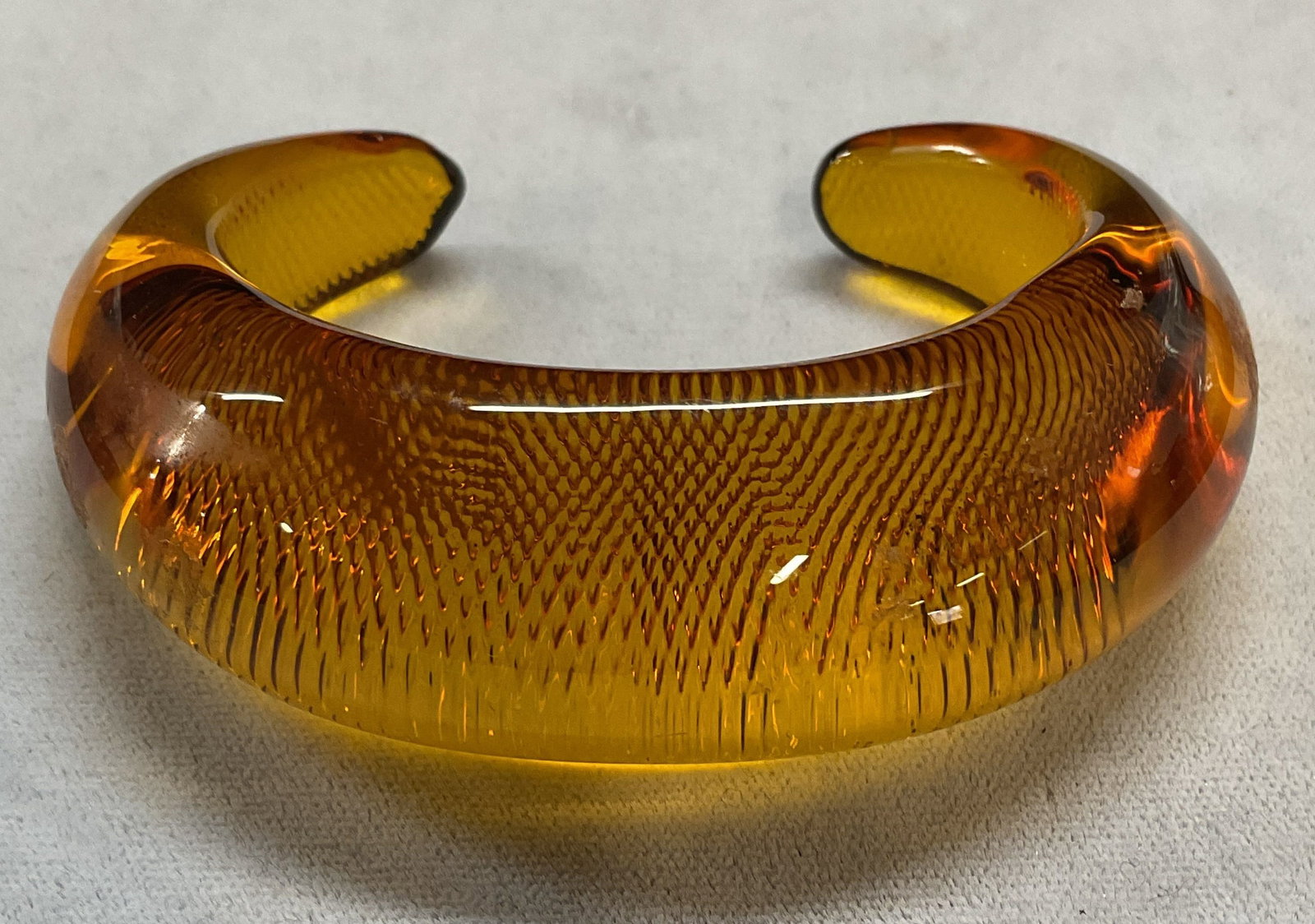 Handmade Amber Art Glass Chunky Cuff Bracelet: Handmade amber art glass textured chunky cuff bracelet. Measures approx 2.25 inches wide. Some wear including scratching observed. Jewelry, estate jewelry, costume jewelry, cocktail jewelry, fashion j