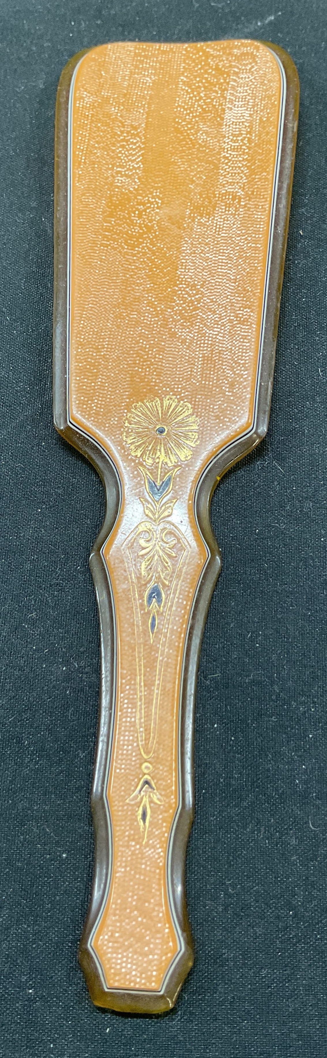 Vtg Pyramid Butterscotch Celluloid Shoe Horn: Vintage pyramid butterscotch celluloid shoe horn. Smooth, curved shape and handle. Floral pattern design. 7 x 1.75 inches. Some surface wear consistent with exposure, some scratching present. Shoe hor