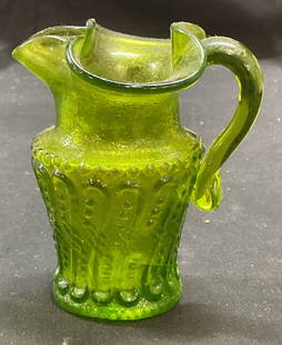 Vintage Green Art Glass Creamer Pitcher: Vintage green art glass creamer pitcher with decorative pattern. Measures approx 3.5 x 3 x 3.75 inches. Some scratching. Art glass pitcher, art glass creamer, green pitcher, green creamer, tableware,