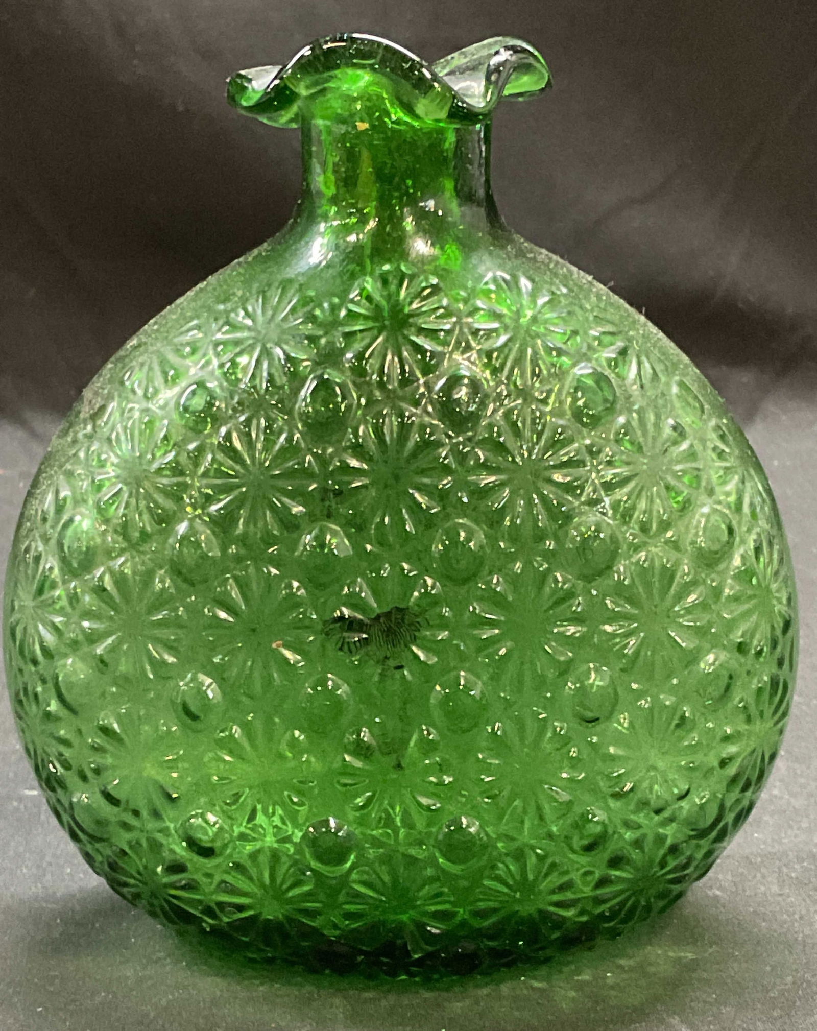 Vintage Green Emerald Glass Handkerchief Vase: Vintage green emerald glass vessel/vase. Raised floral dot pattern with handkerchief rim. Measures approx 5 x 2.5 x 5.5 inches. Some scratching observed. Vase, handkerchief vase, green vase, glass vas