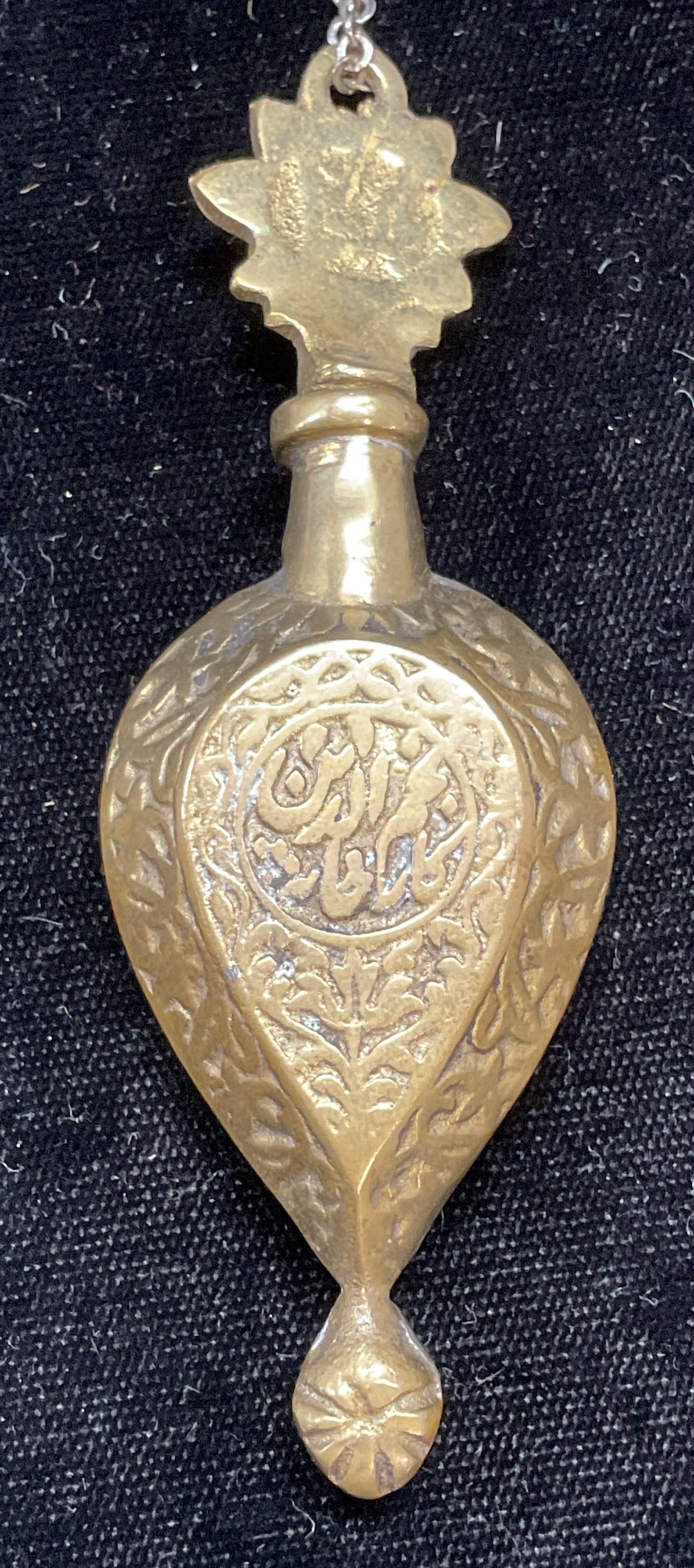 Vintage Heavy Brass Snuff Bottle Pendant: Vintage heavy brass snuff bottle pendant with chain. Raised detail. Measures approx 3.5 x 1.25 inches. Chain drop approx 13 inches. Some wear including scratching observed. Jewelry, estate jewelry, co