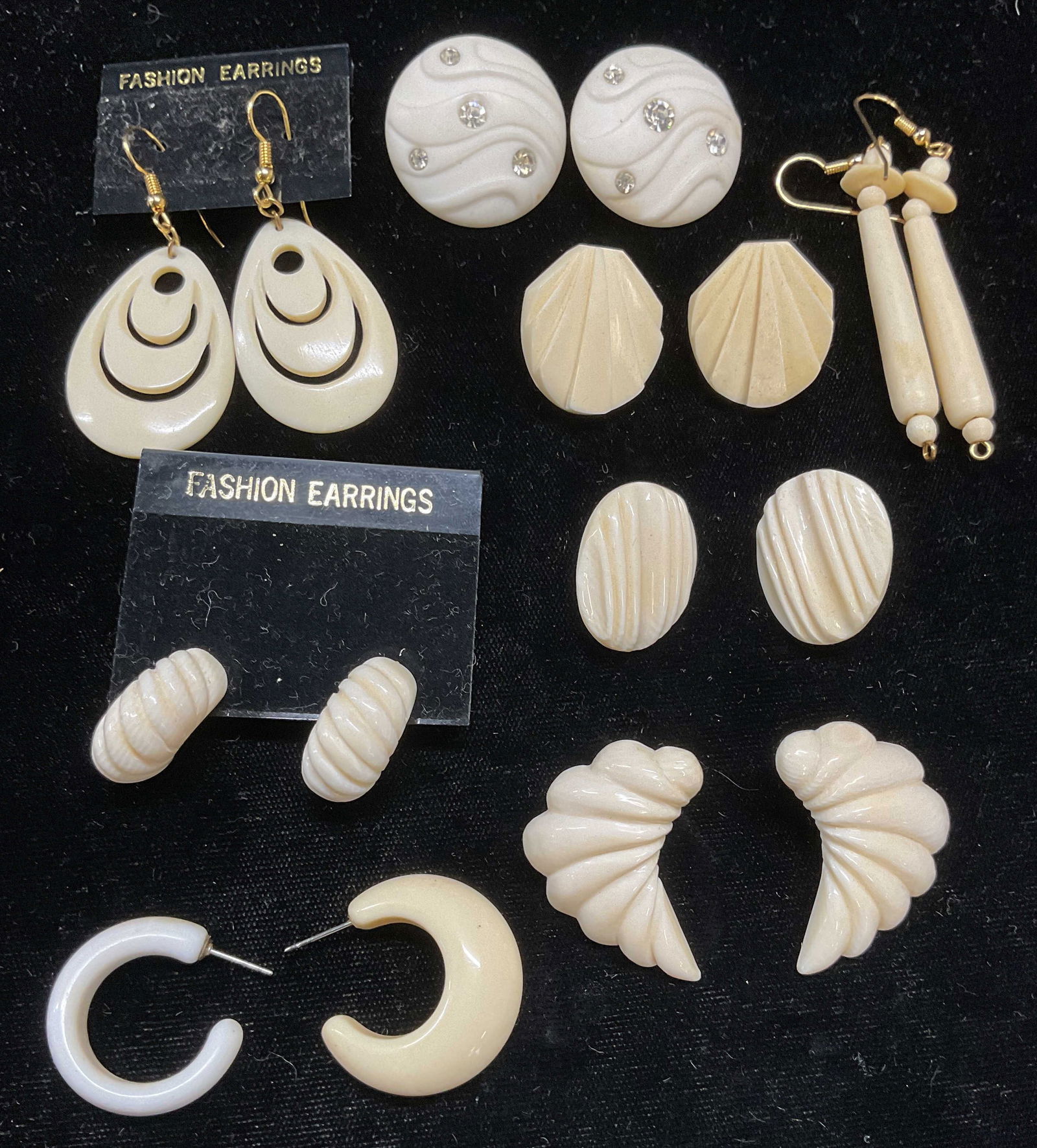 Lot 9 Vintage Carved White Earrings: Lot of 9 pieces. 7 pairs and 2 single carved white earrings. Some pieces appear to be bone. Largest approx 2 inches long. Some wear including scratching observed. Jewelry, estate jewelry, costume jewe